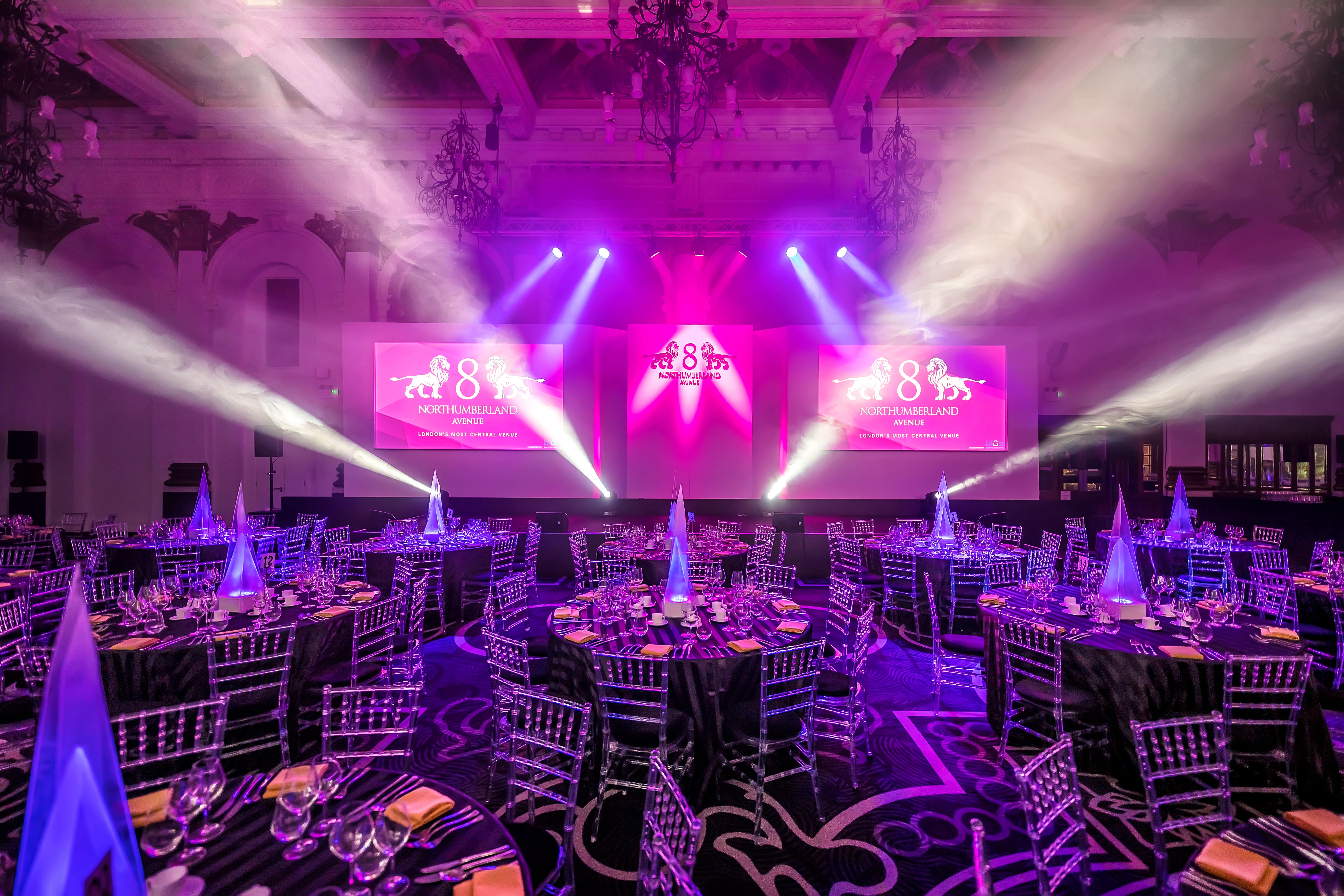 Elegant ballroom with round tables, ideal for gala and awards ceremonies.