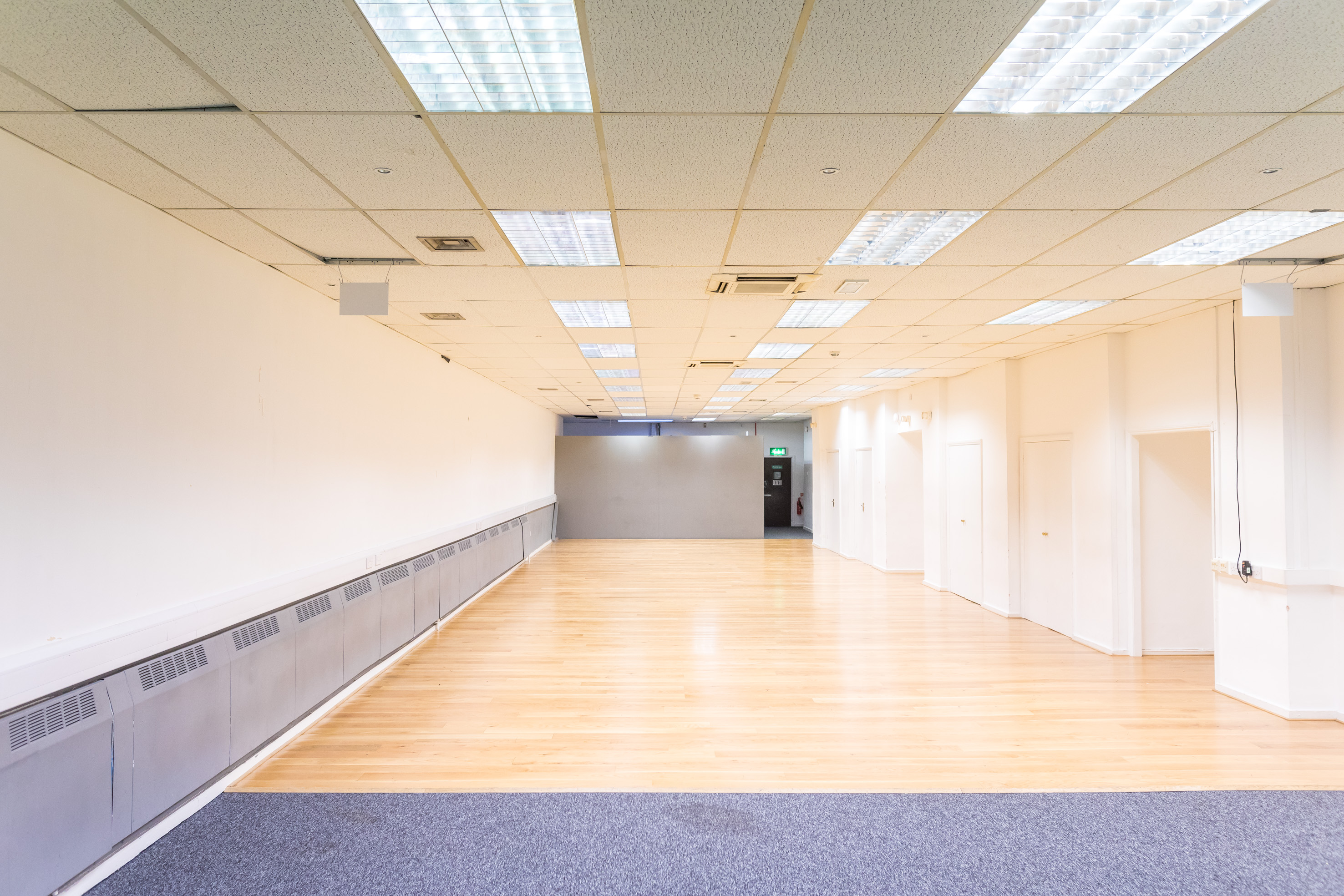 Spacious event space at Dominion Theatre with hardwood flooring for corporate meetings and workshops.