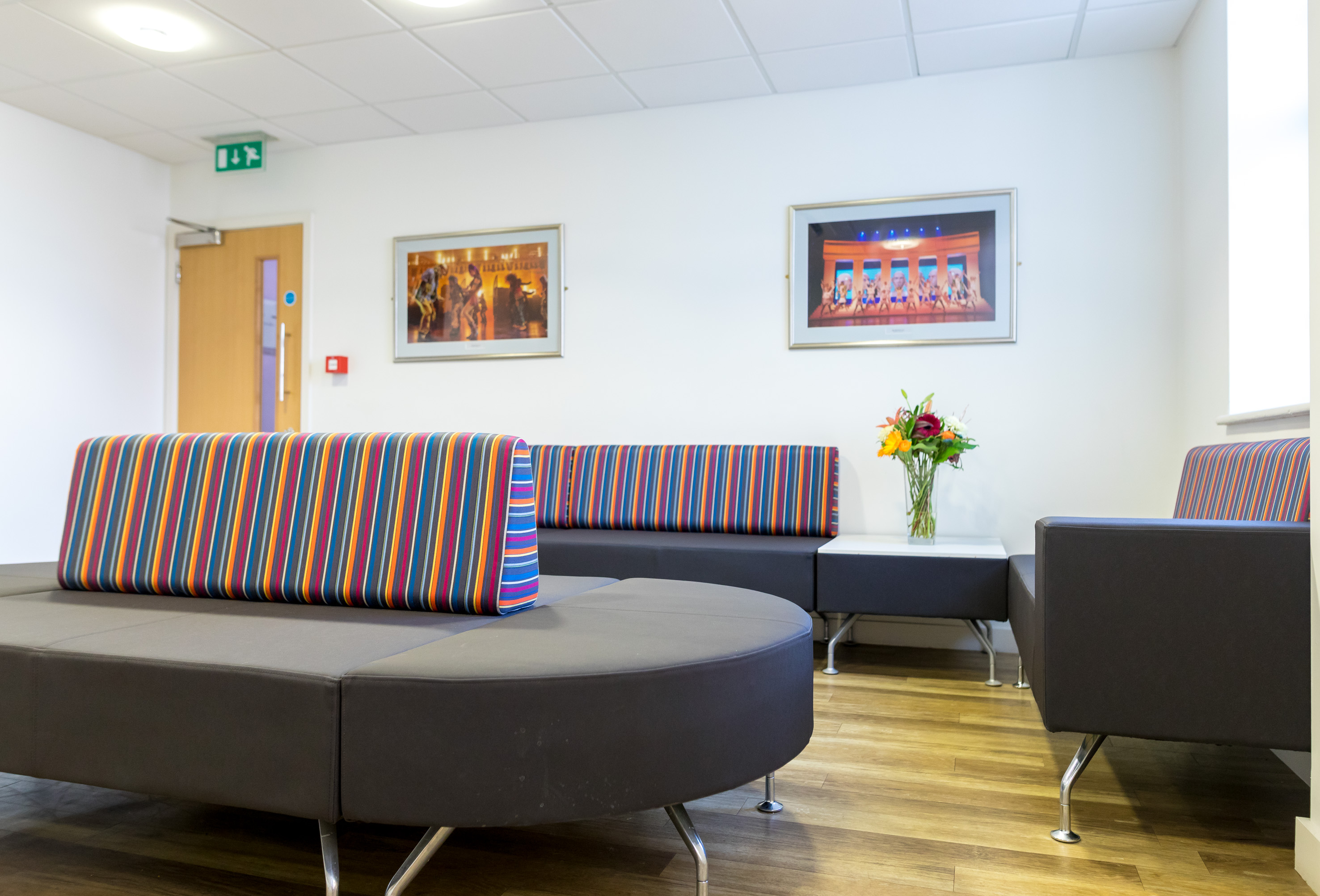 Modern lounge area with colorful seating at Dominion Theatre for networking events.