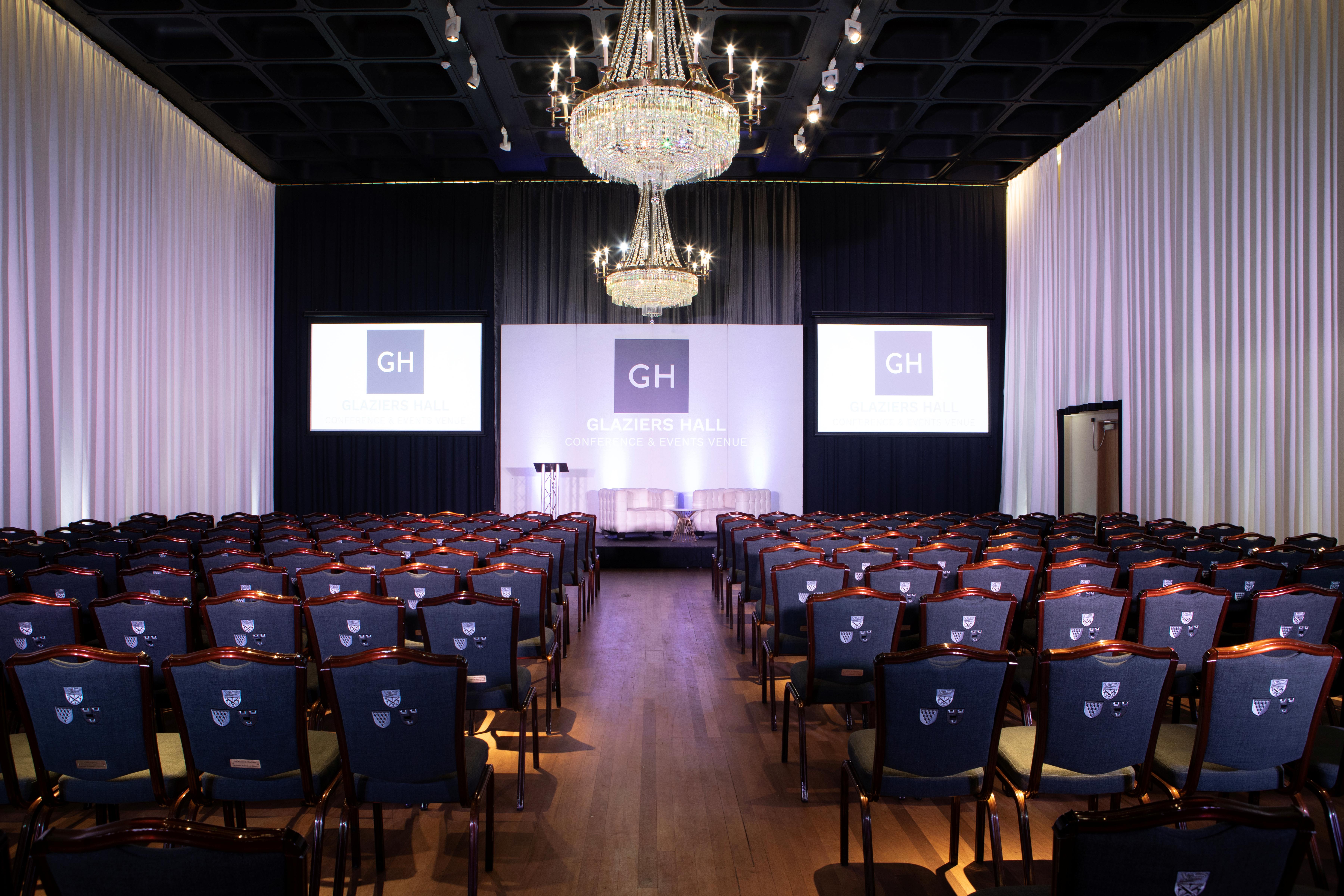 Elegant Banqueting Hall setup for conferences with spacious layout and chandelier lighting.