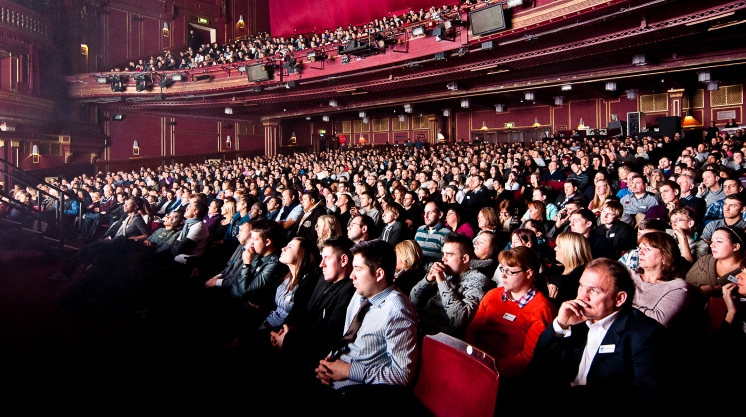 Packed Dominion Theatre auditorium showcasing vibrant event atmosphere and audience engagement.