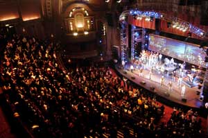 "Dominion Theatre auditorium with vibrant audience at a dynamic concert event."