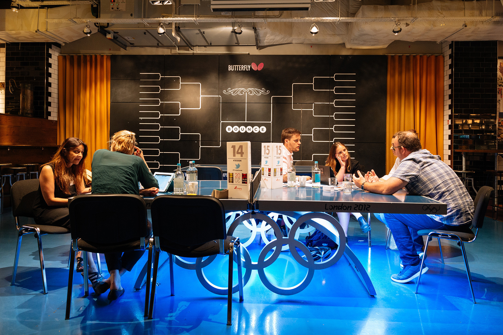 Modern conference space with sleek table, ideal for workshops and team-building activities.