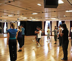 Group dance rehearsal in spacious studio with mirrored walls, ideal for workshops and retreats.