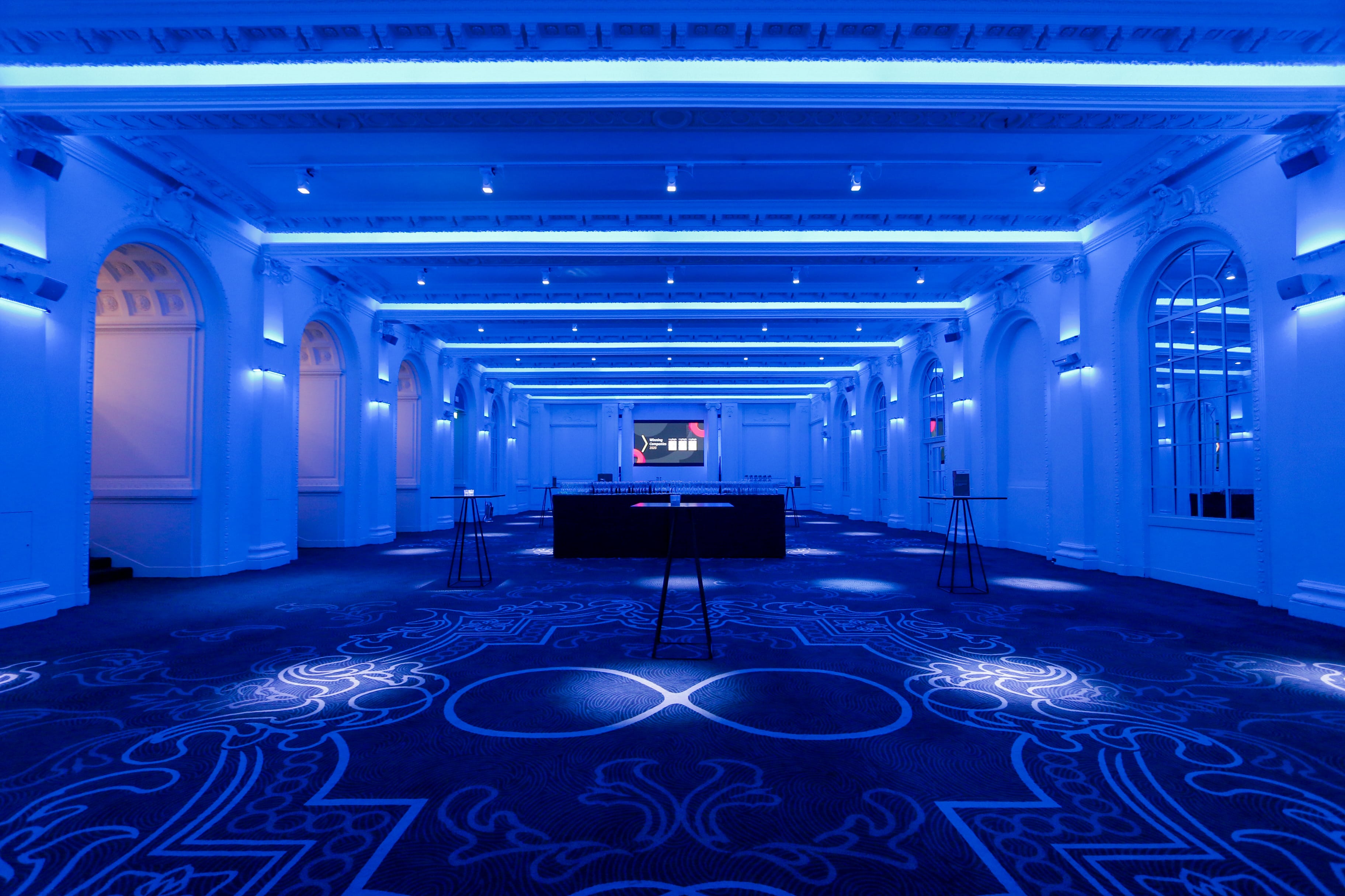 Old Billiard Room venue with blue lighting, ideal for corporate events and upscale gatherings.