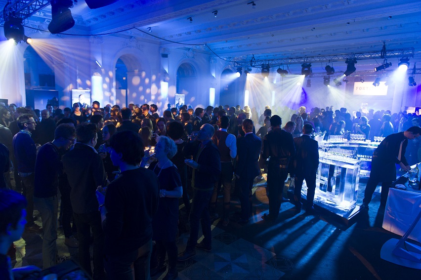 Networking event in Old Billiard Room, vibrant atmosphere with sleek bar setup.