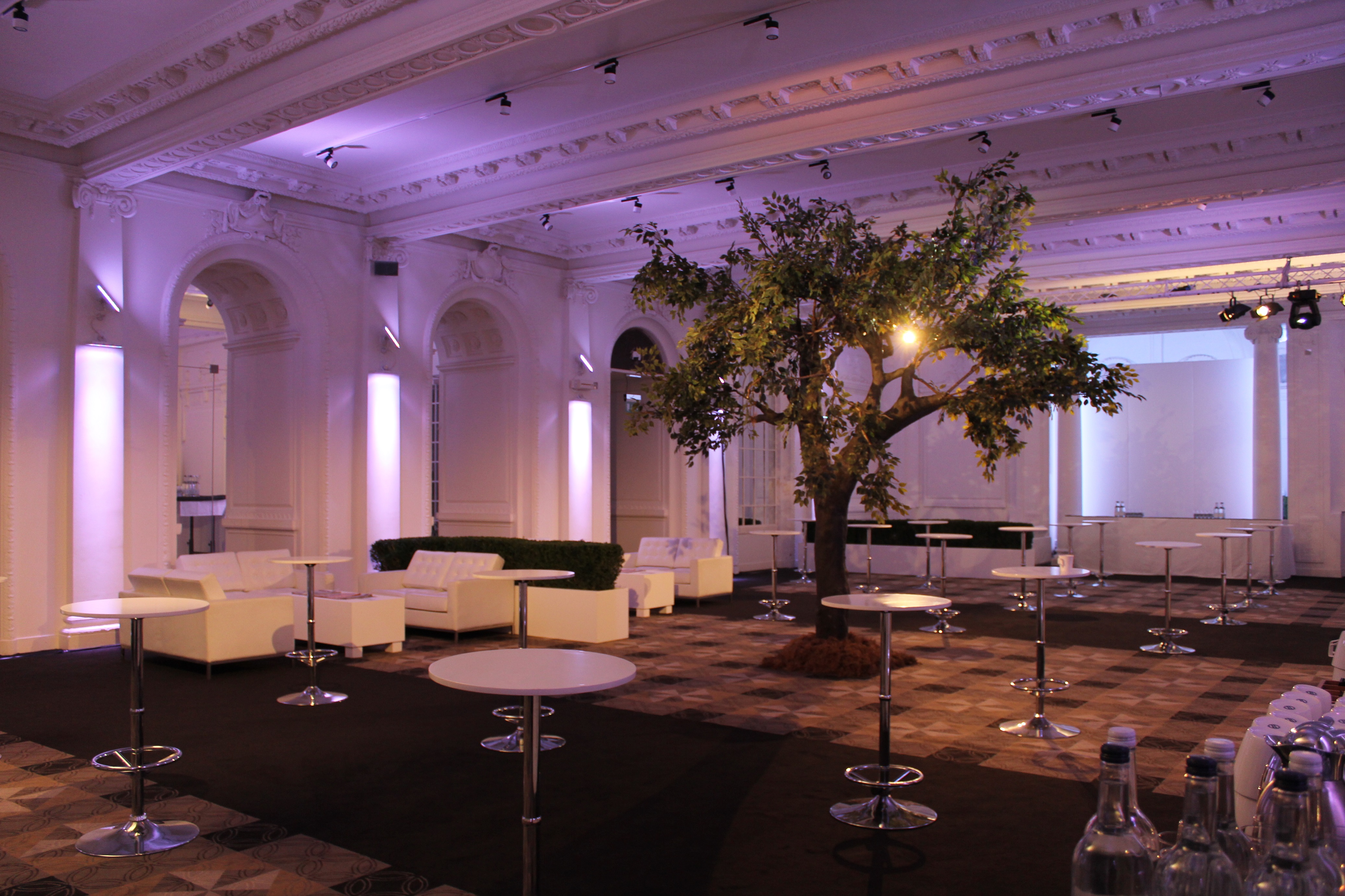 Old Billiard Room event space with modern seating and central tree for gatherings.