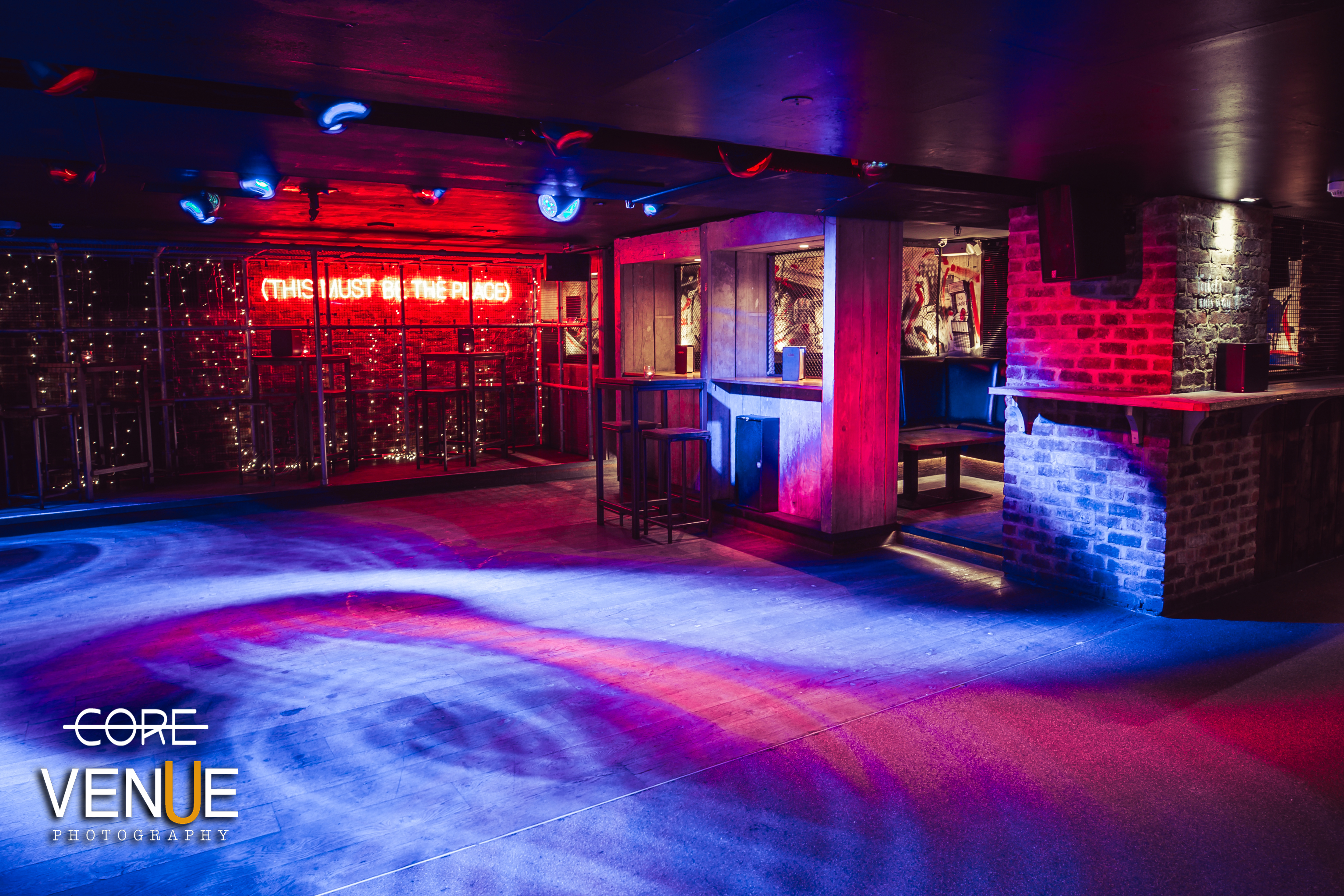 Versatile event space in Core Bar with modern decor for corporate and social gatherings.