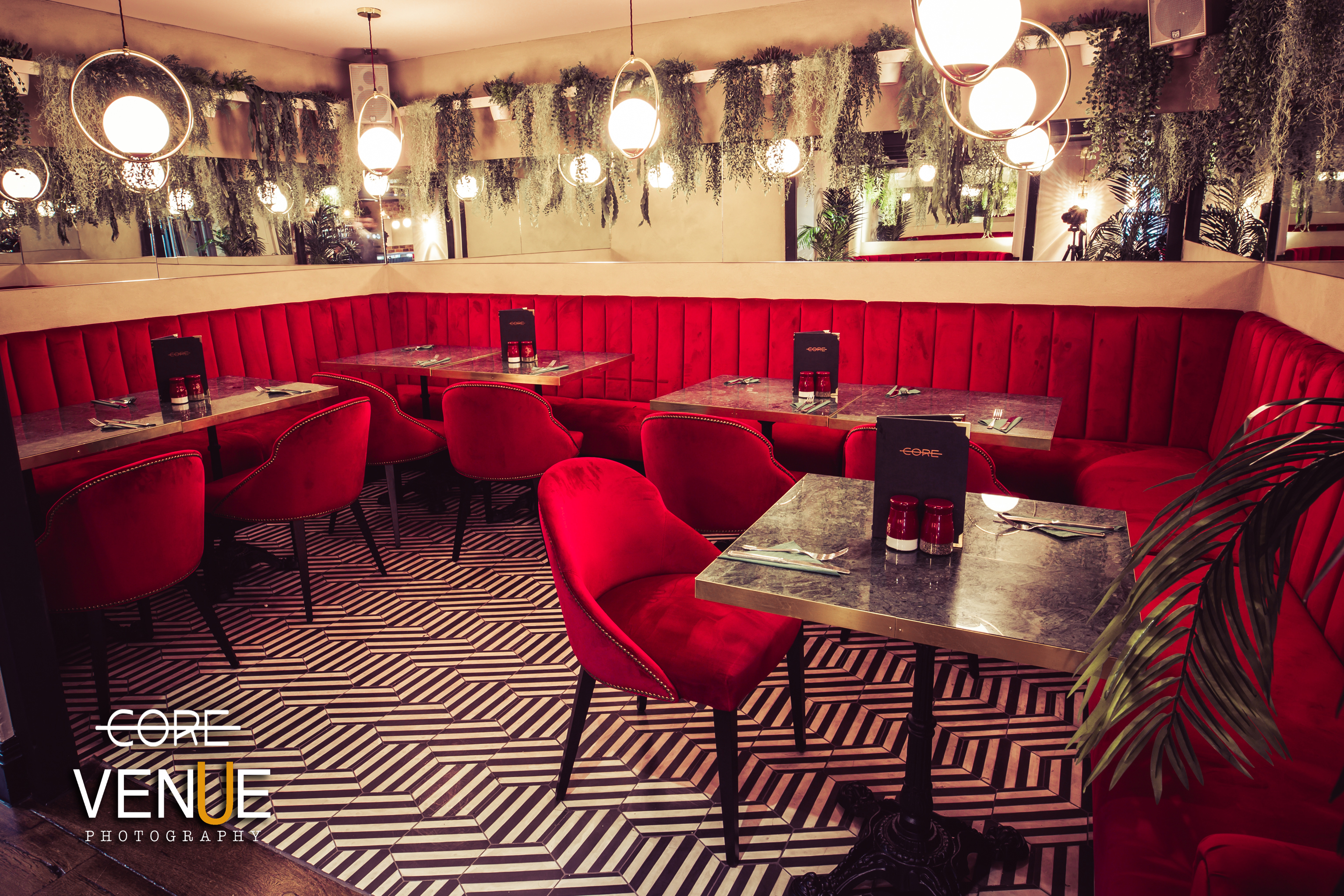 Stylish dining area with red seating, perfect for networking events and gatherings.