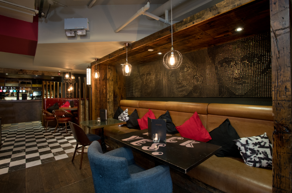Stylish lounge in Core Bar with warm wood tones, ideal for casual events and meetings.
