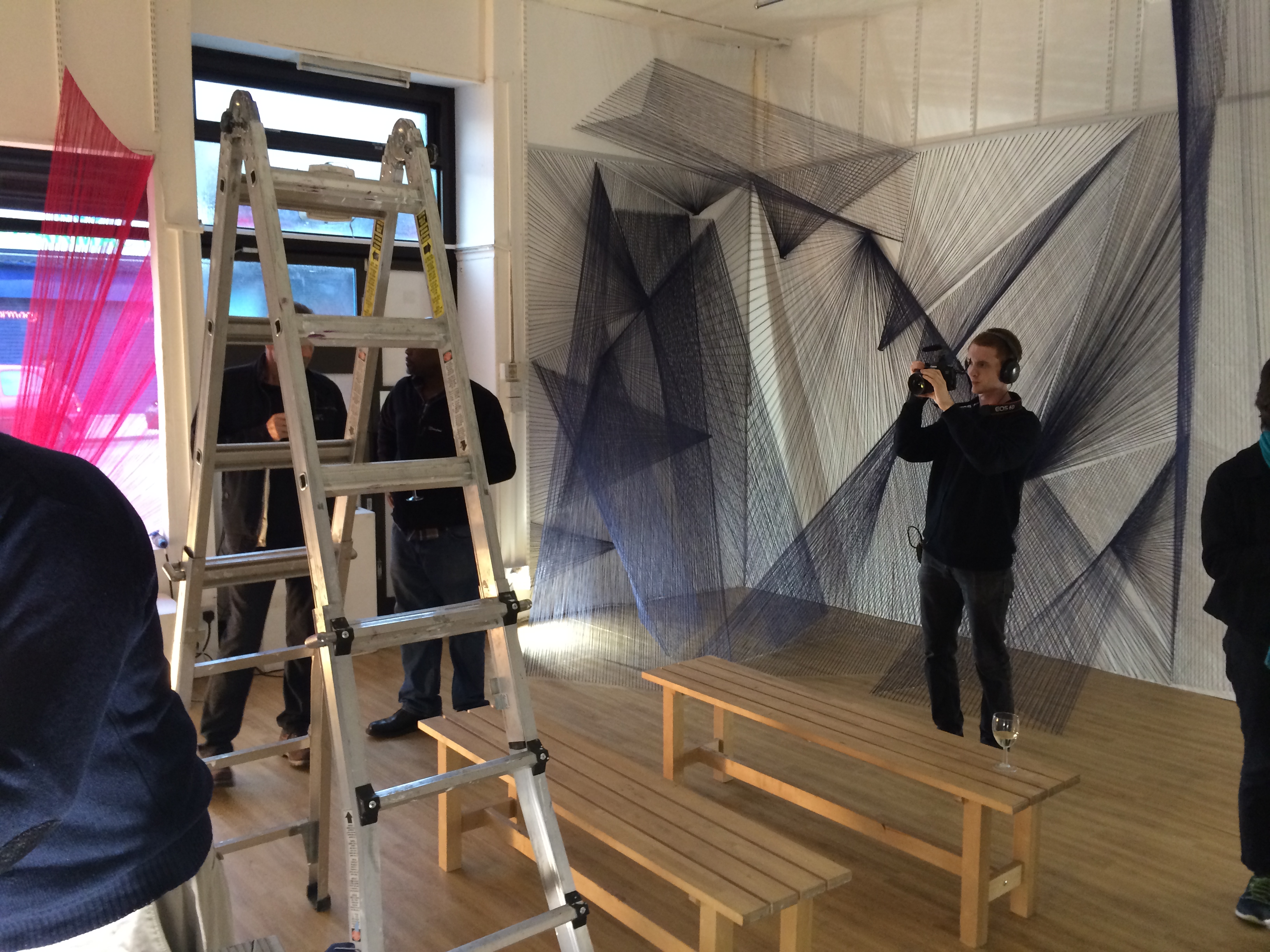 Colorful string installation in BAR Gallery, showcasing creative event space setup.