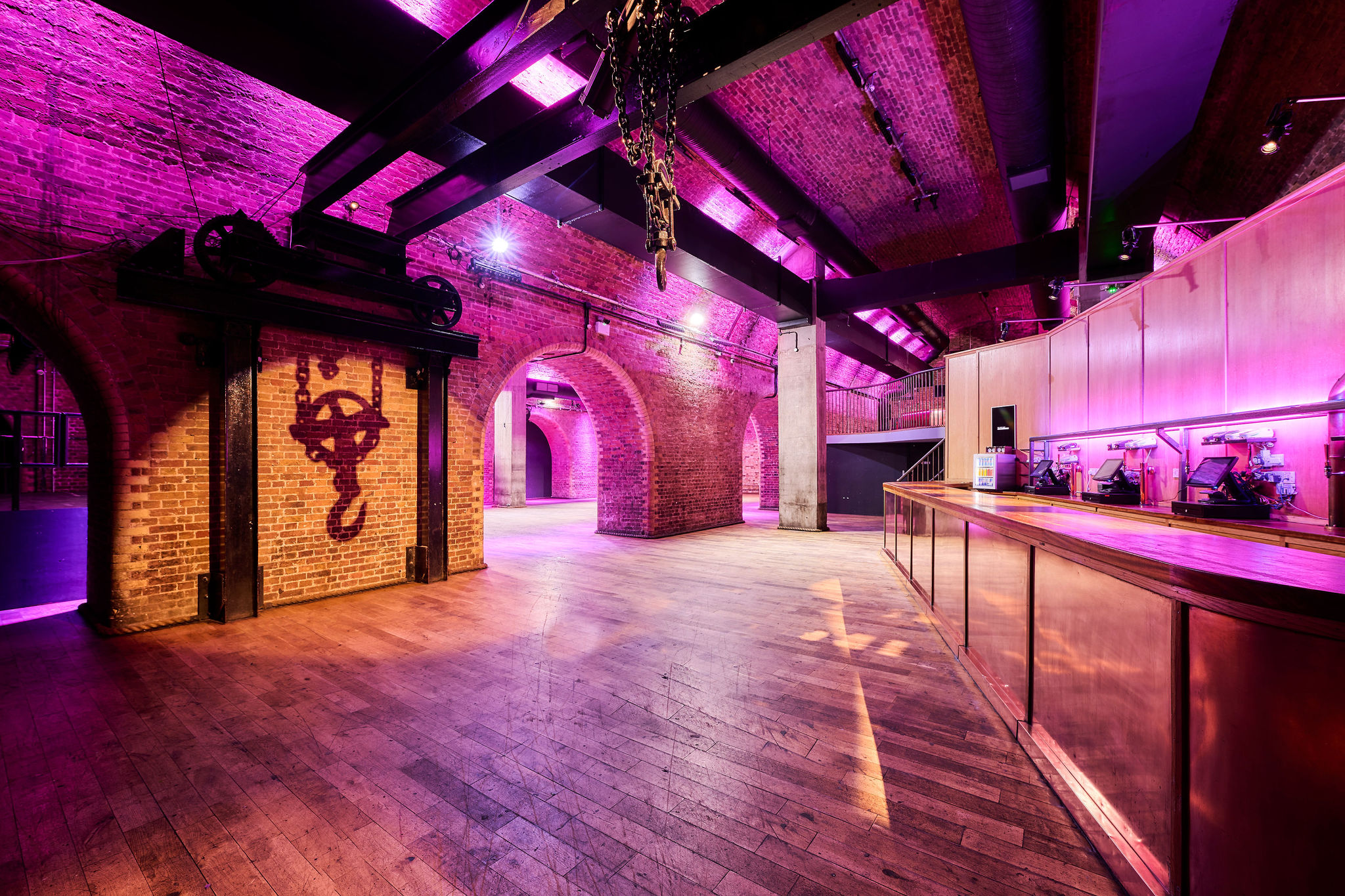 Versatile event space with exposed brick walls, ideal for corporate meetings and social gatherings.