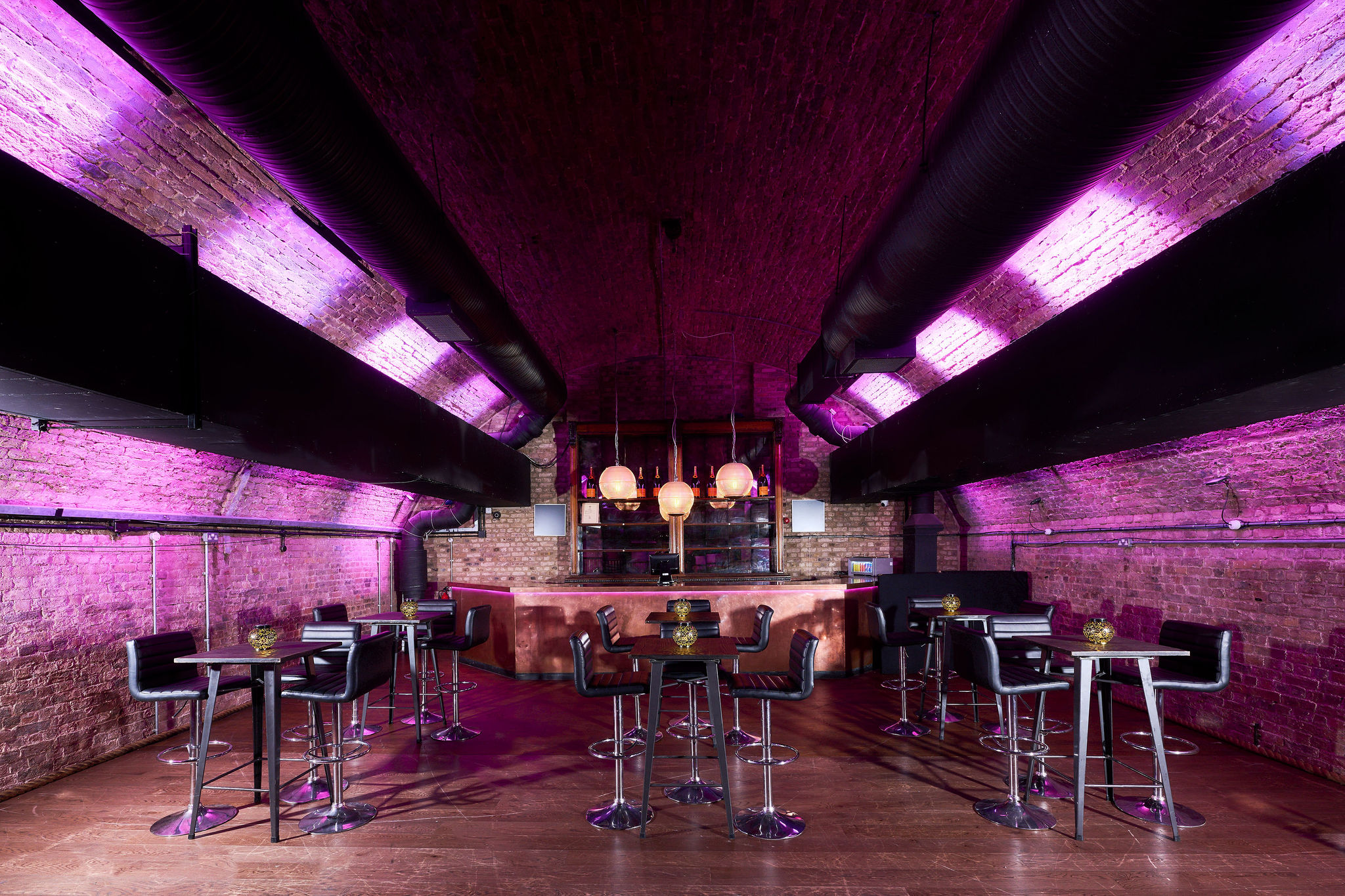 Stylish modern event space with purple lighting, ideal for cocktail receptions and private gatherings.