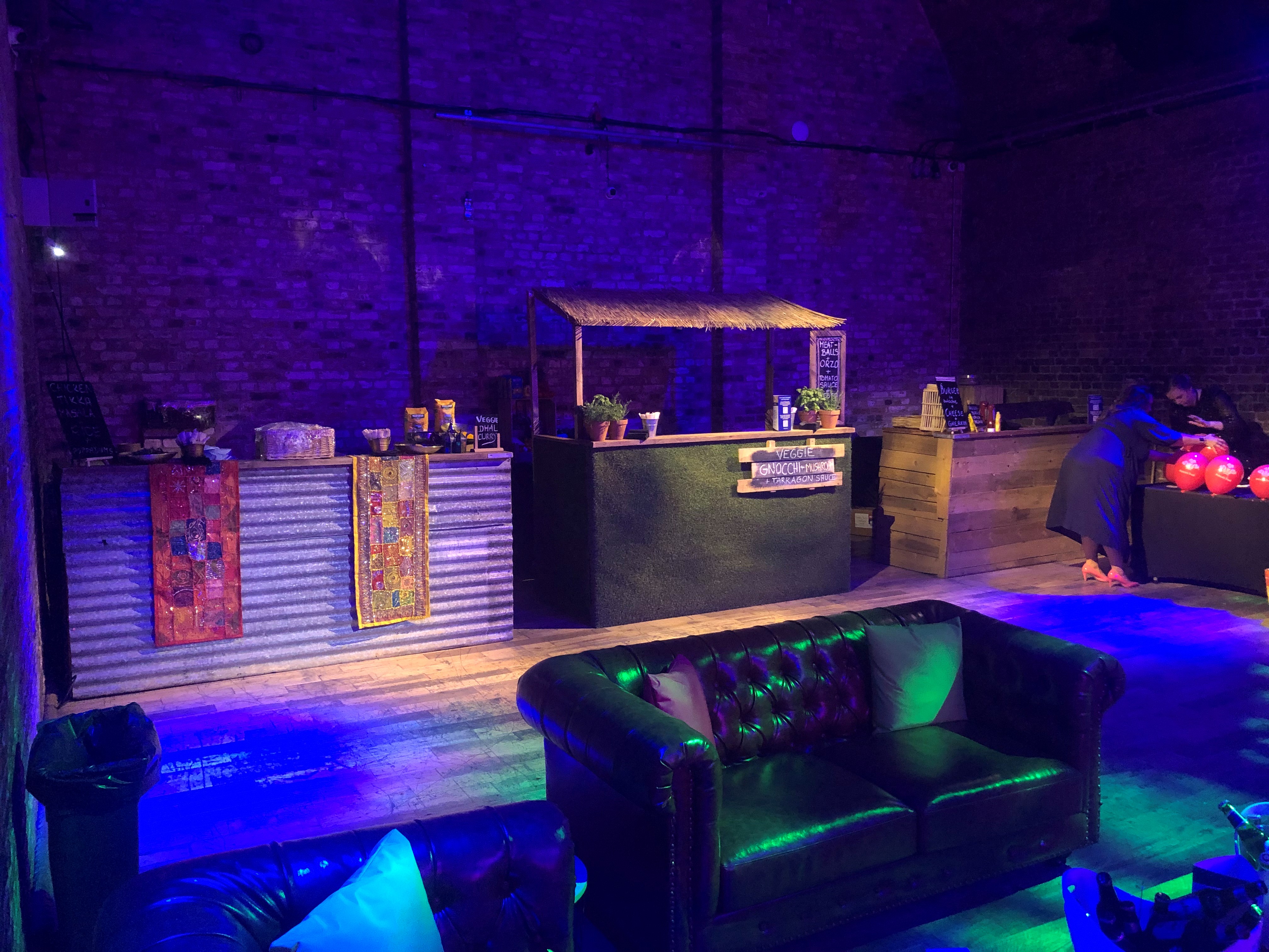 Whole Venue at The Steel Yard: rustic bar, vibrant lighting for events and gatherings.