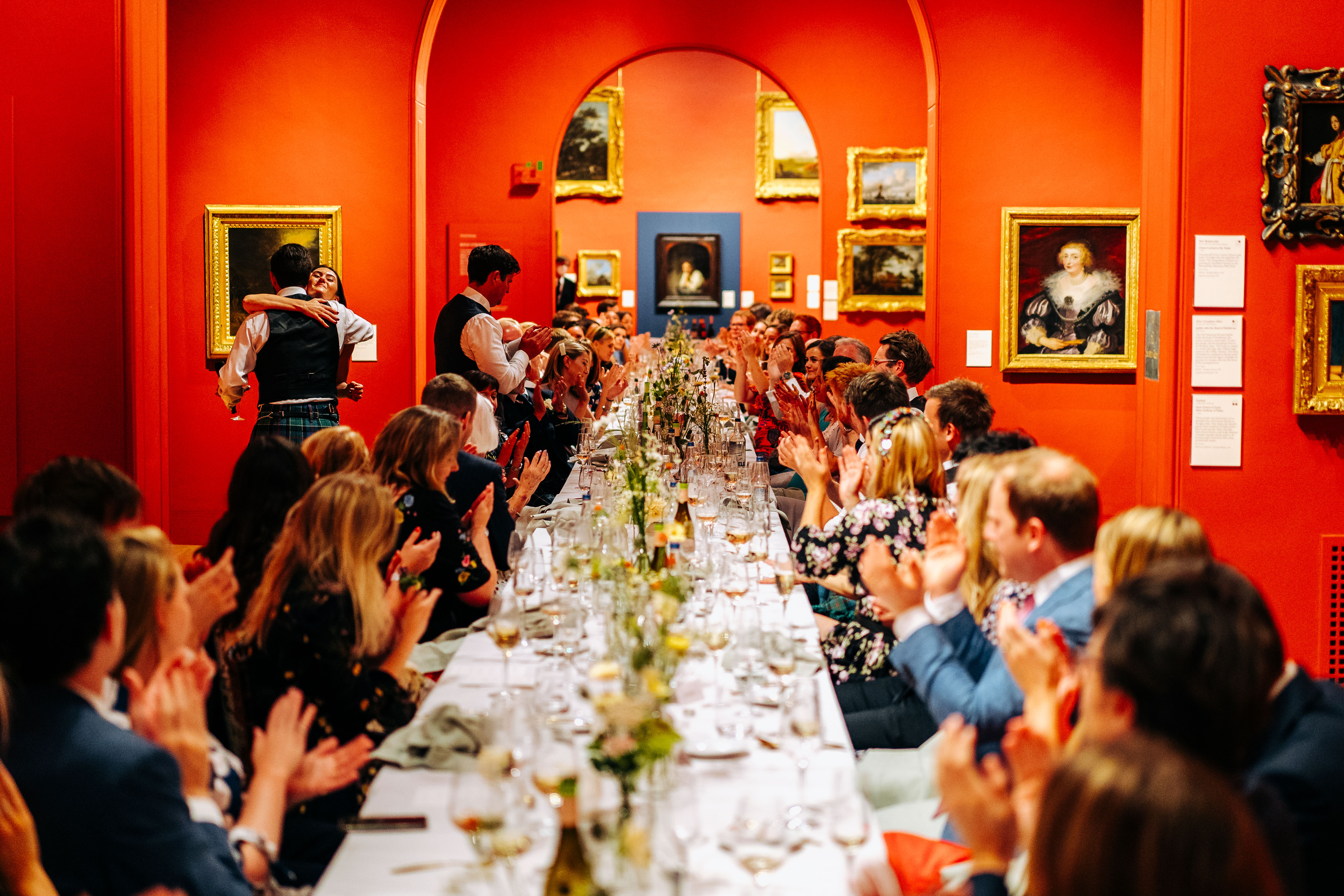 Elegant dinner event at The Soane Gallery with engaged guests and vibrant decor.