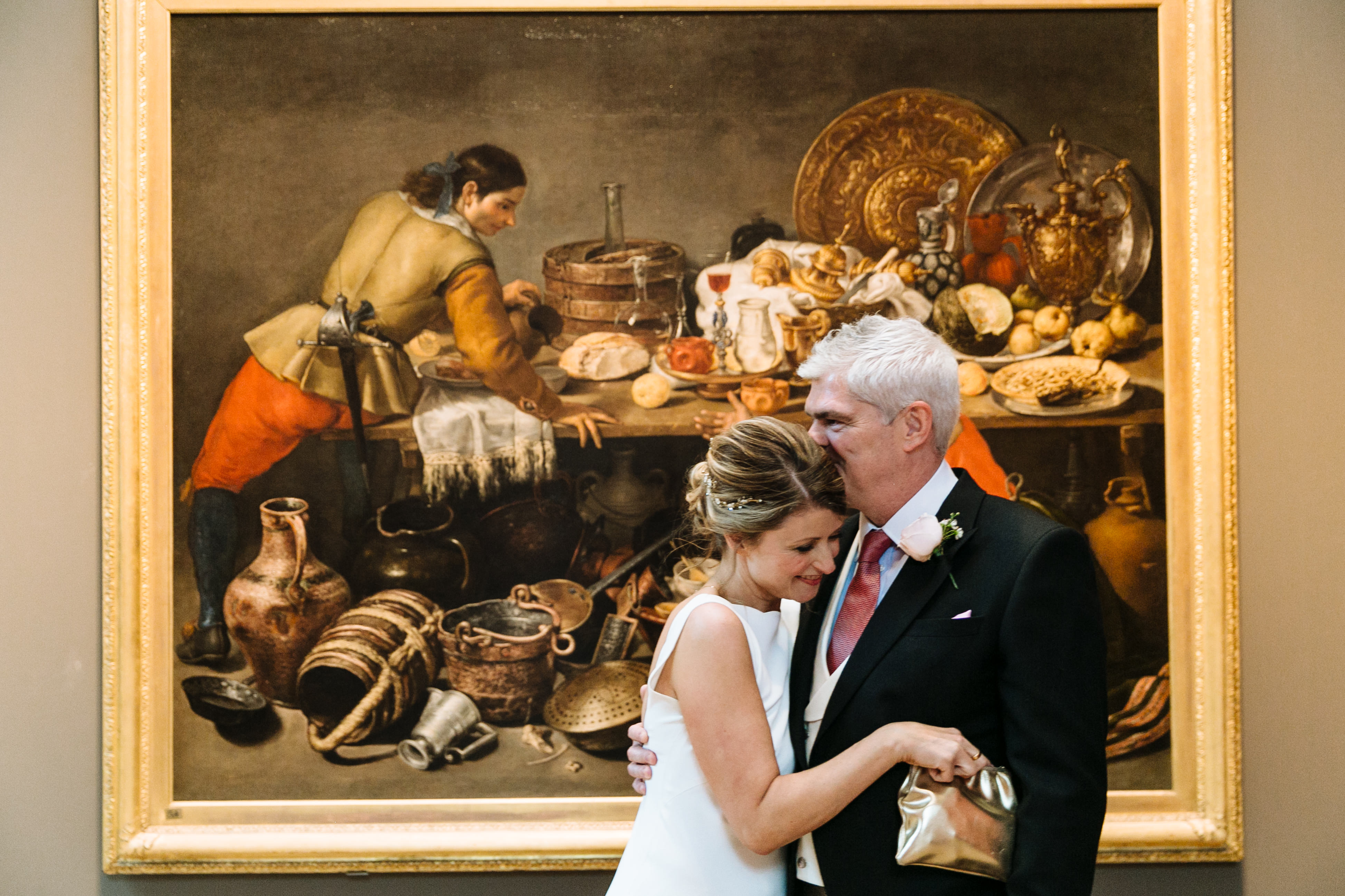 Couple embracing in front of still-life painting at The Soane Gallery, Dulwich Picture Gallery.