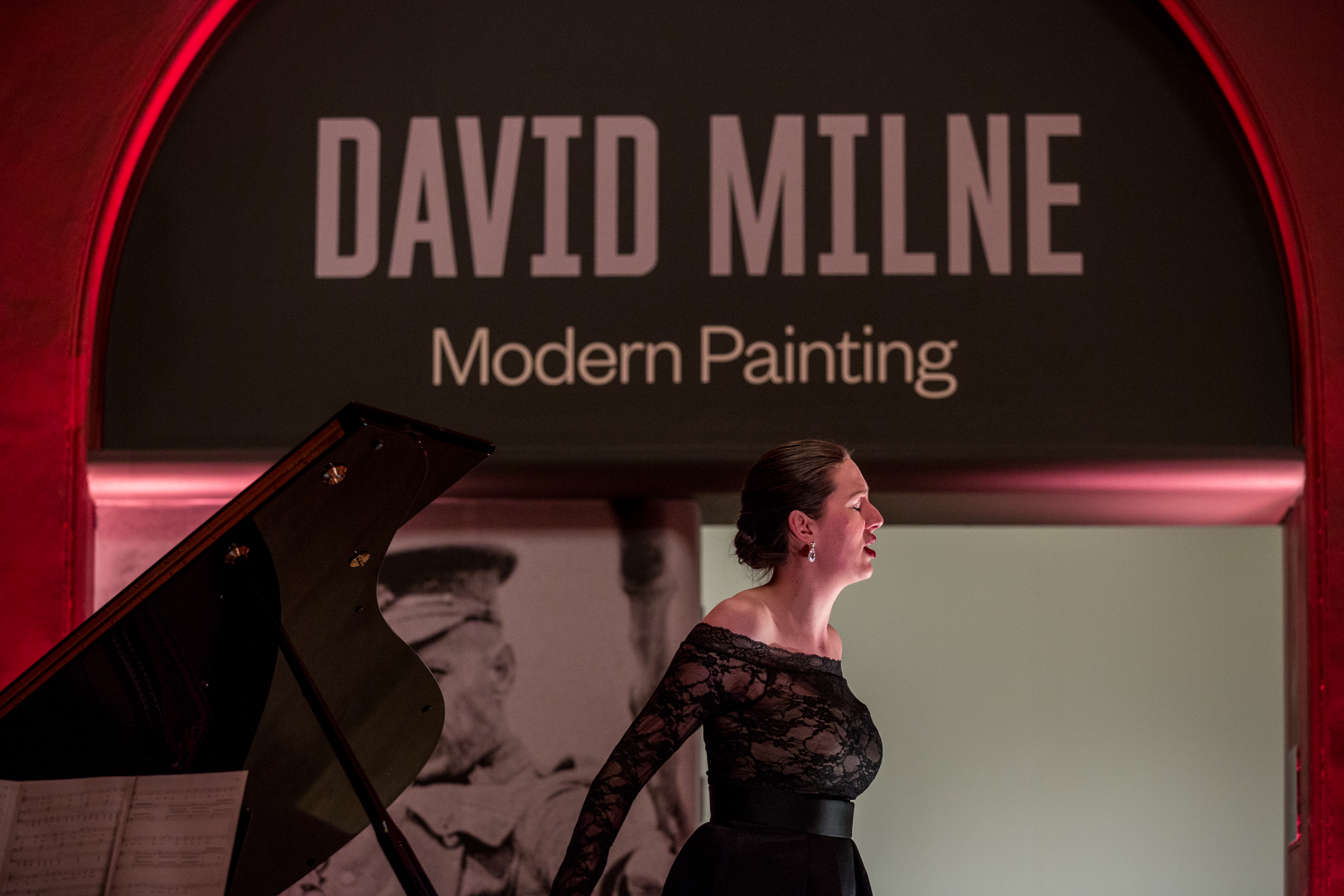 Elegant performer in black dress at The Soane Gallery art exhibition gala.