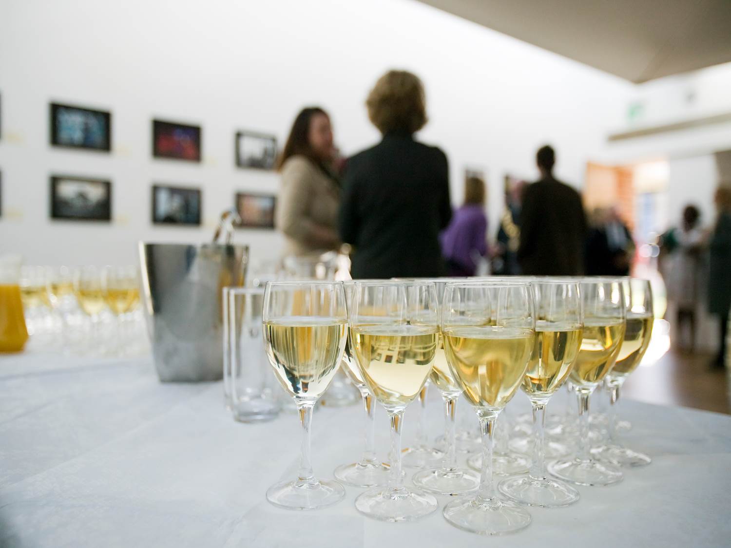 Sophisticated networking event in The Linbury Room with champagne and art ambiance.