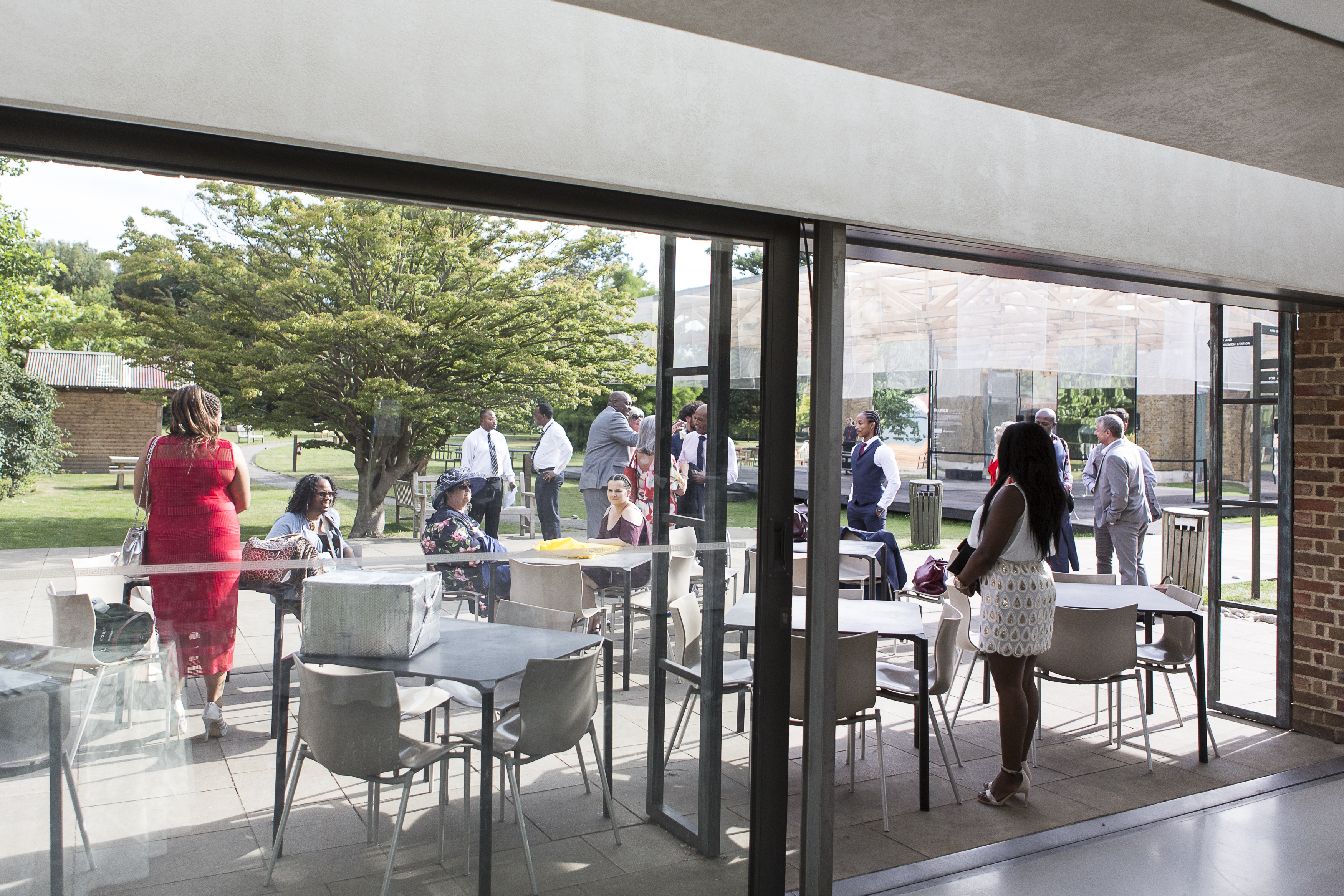 Outdoor networking event at Gallery Cafe, featuring large glass windows and vibrant atmosphere.