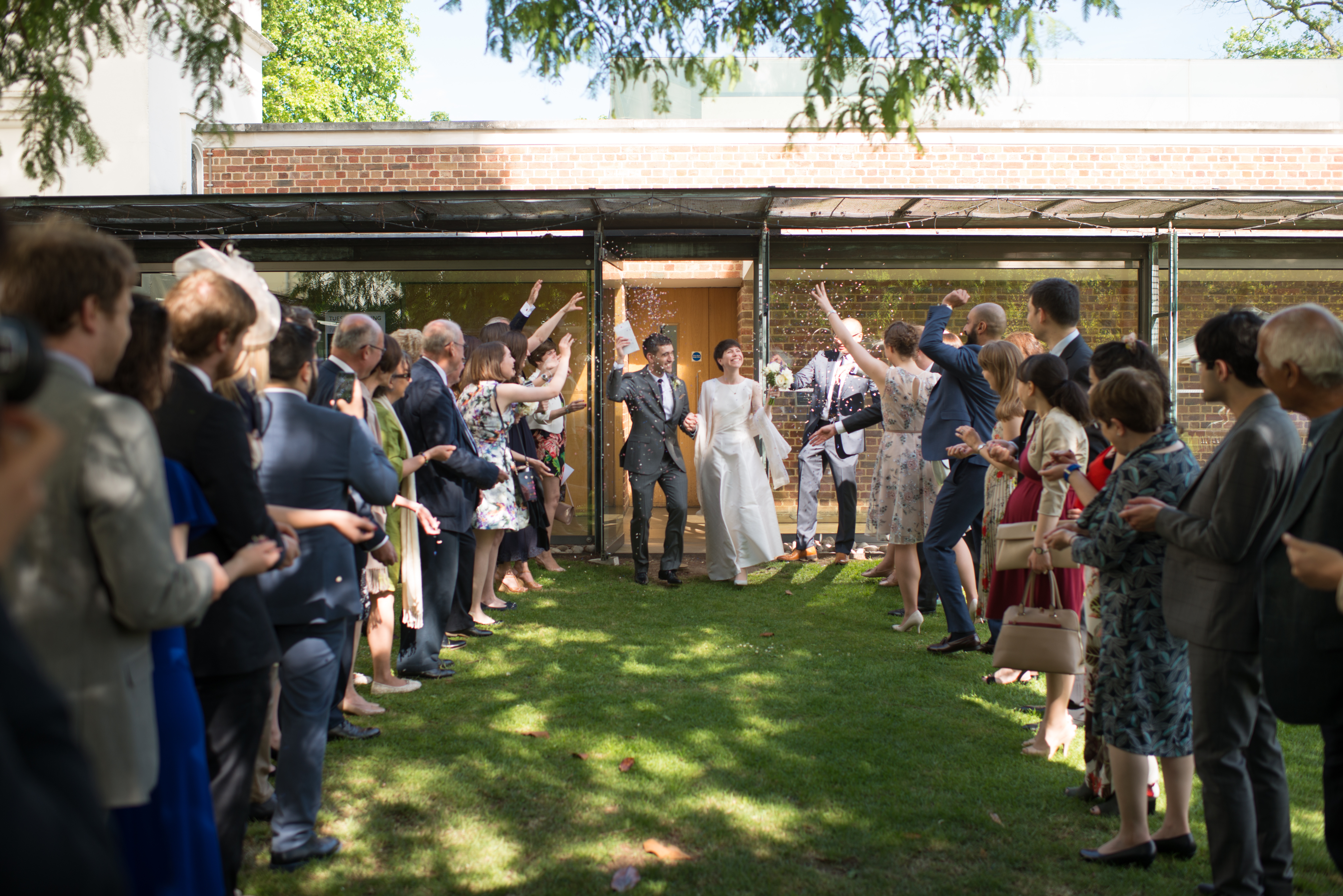 Joyful outdoor wedding at Gallery Cafe, Dulwich with lush lawn and modern architecture.
