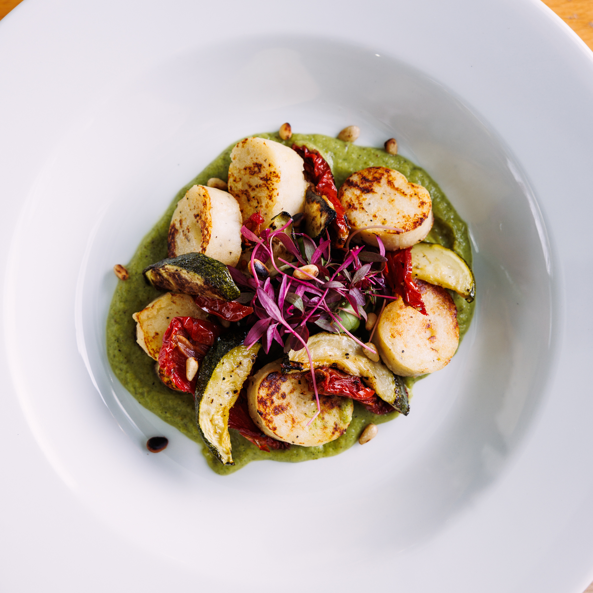 Seared scallops on green sauce at The Jam House, perfect for events and culinary aesthetics.