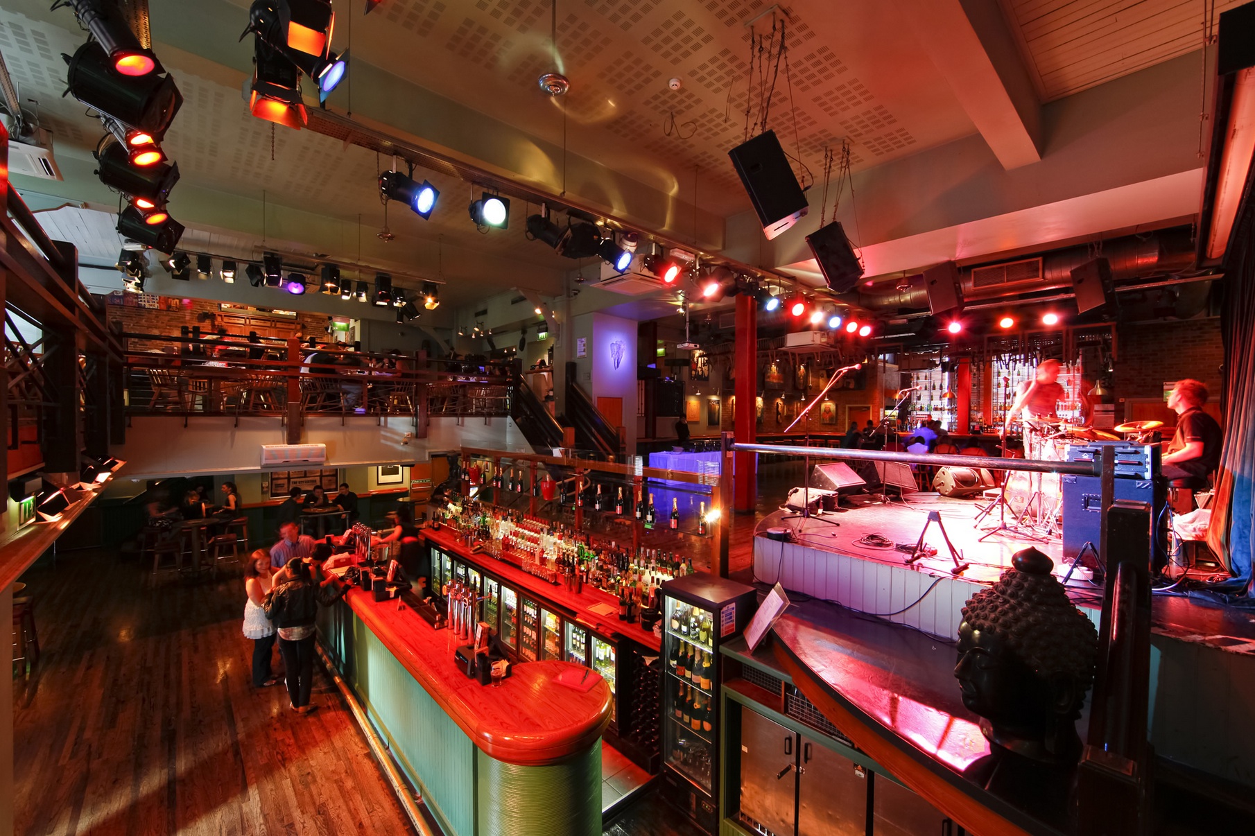 Vibrant event space at The Jam House with bar and stage for corporate events and live music.