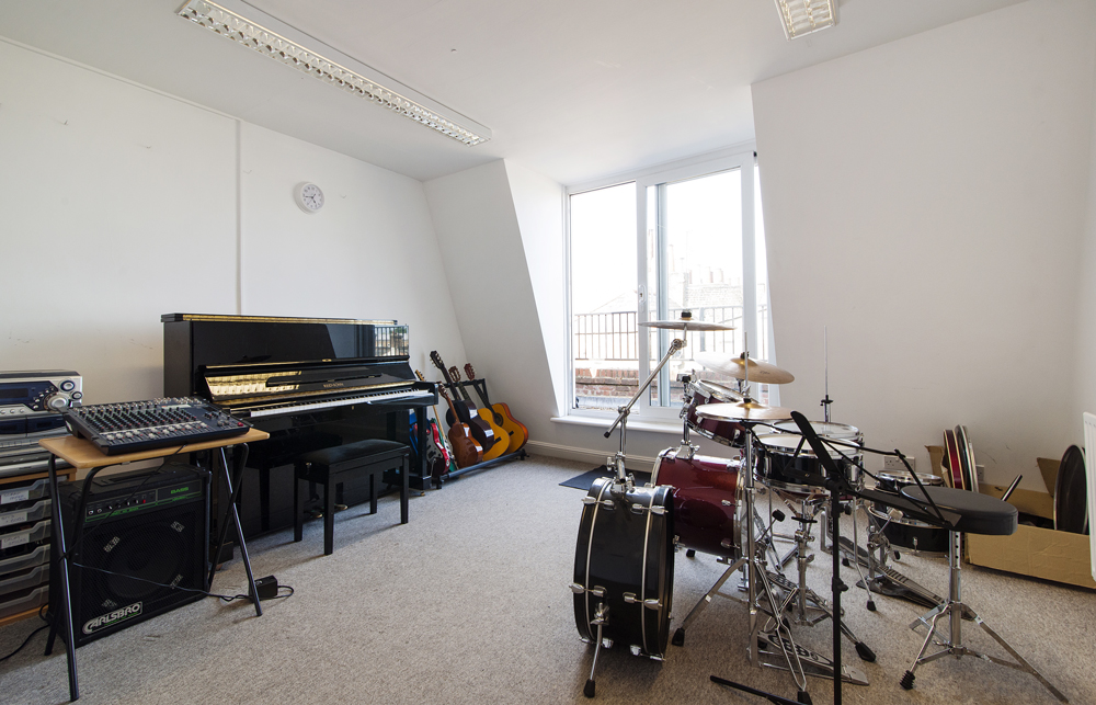 Large Music Room in artsHouse with piano, ideal for creative workshops and events.