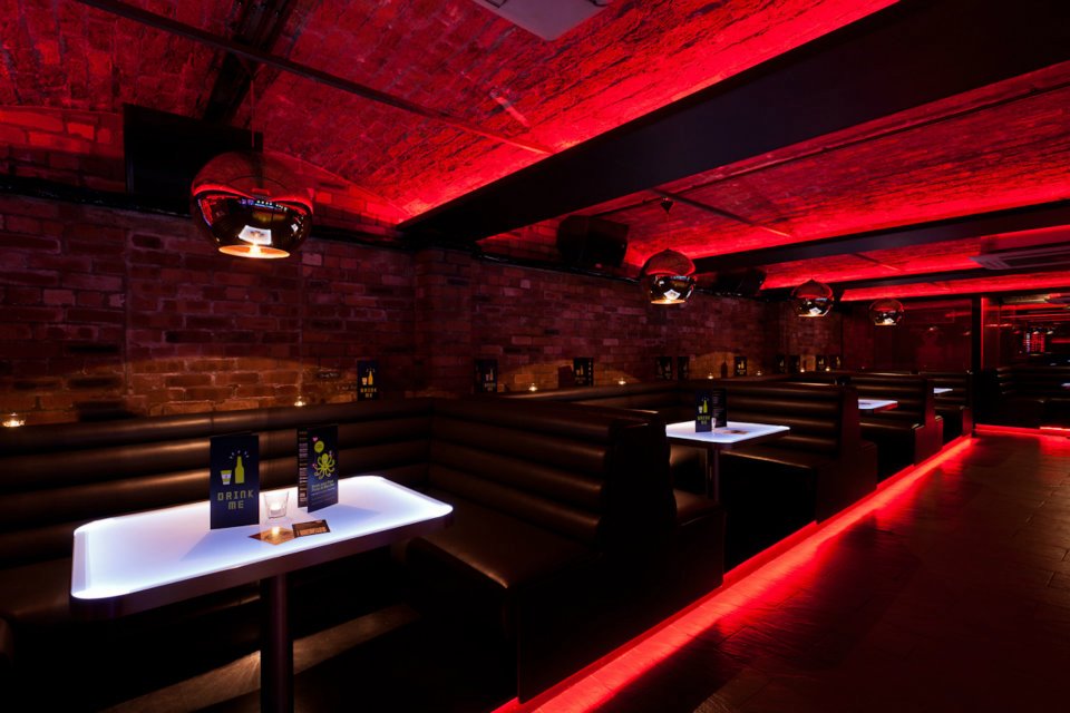 Stylish venue with red lighting, perfect for networking events and private gatherings.