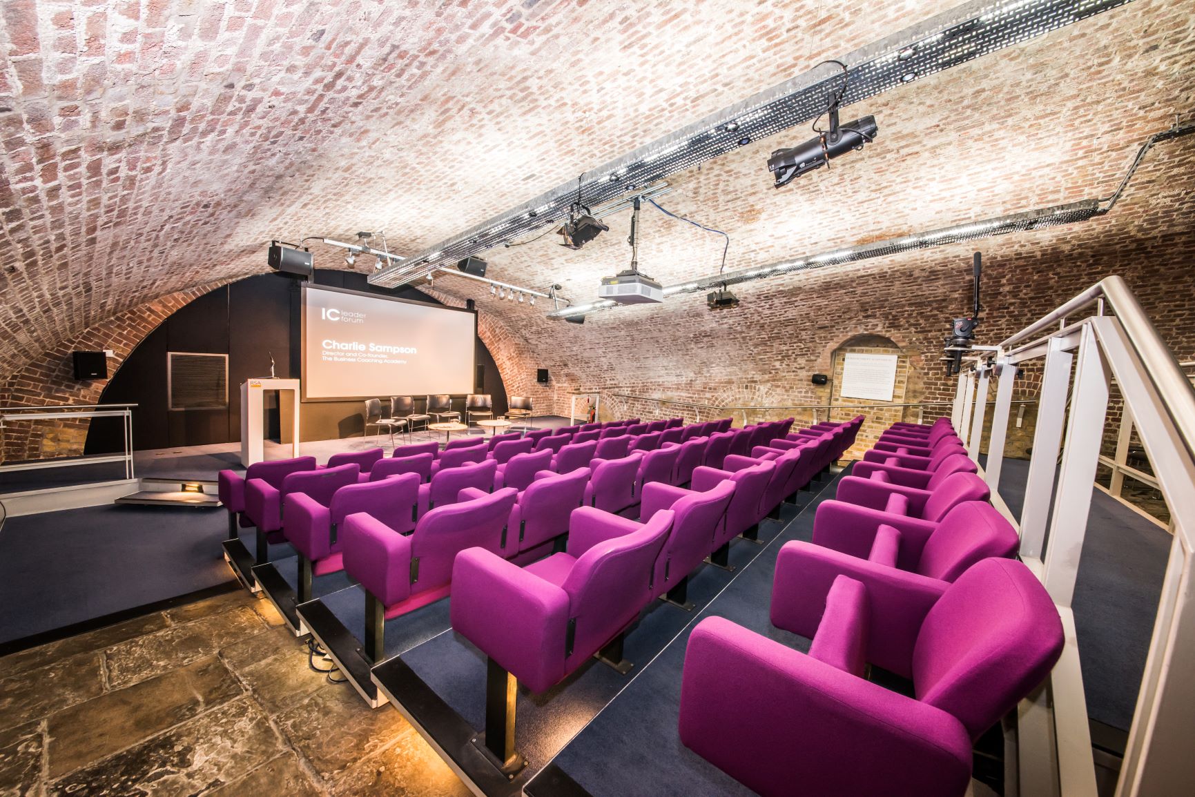 Durham Street Auditorium with modern purple seating, ideal for conferences and workshops.