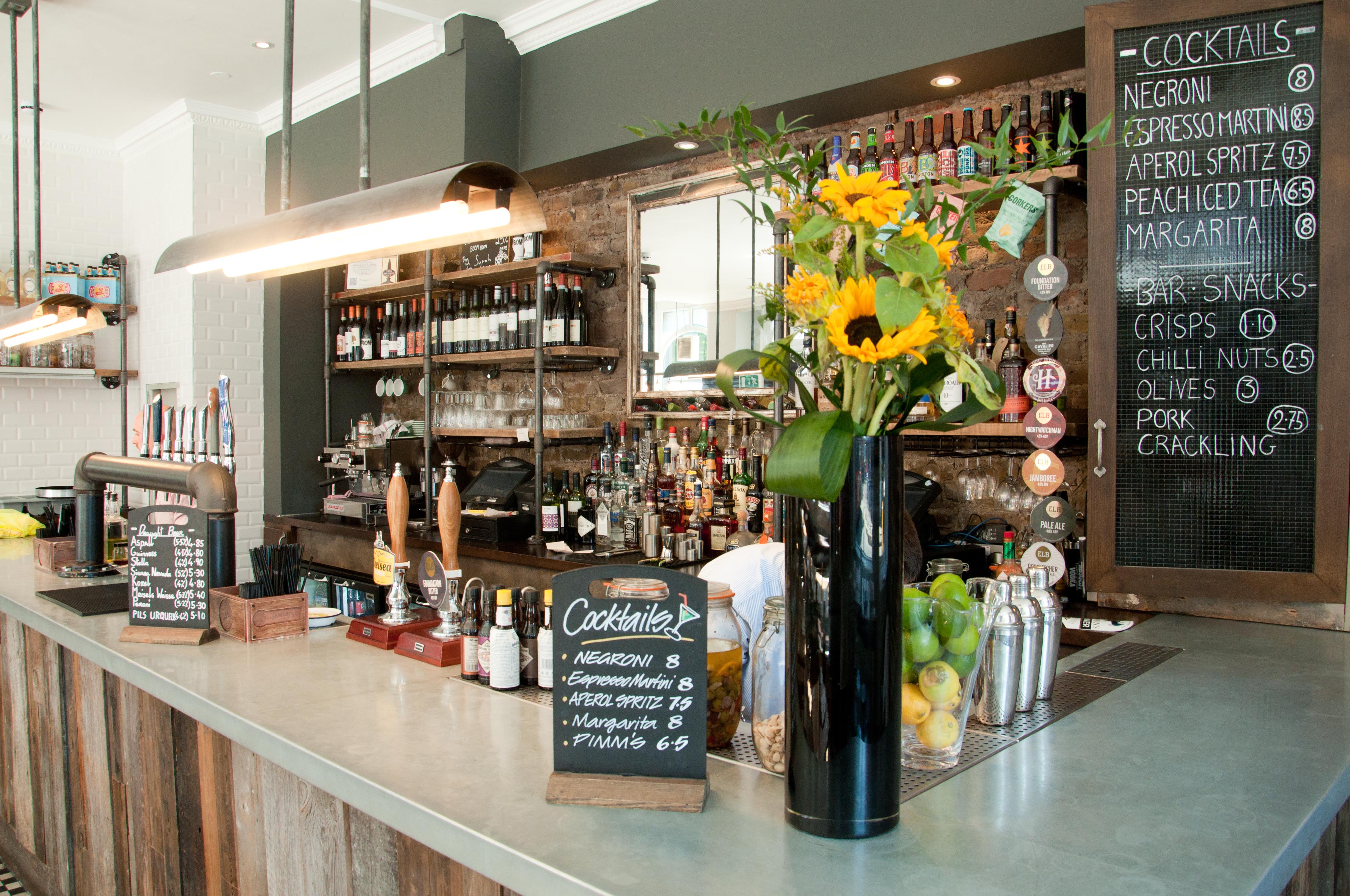 Stylish bar setup with vibrant flowers for networking events at The Yorkshire Grey.