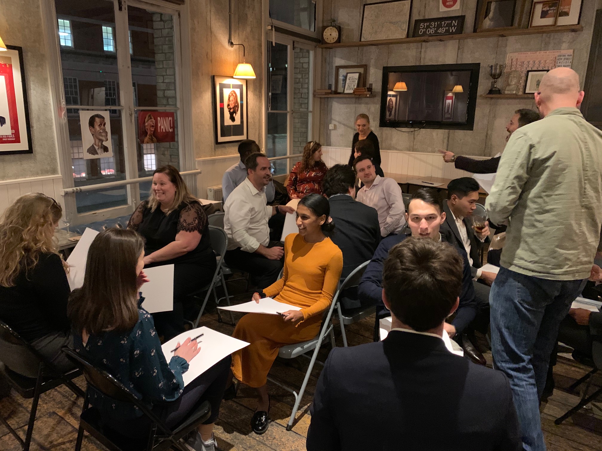 Networking event in cozy Yorkshire Grey meeting room with warm lighting.