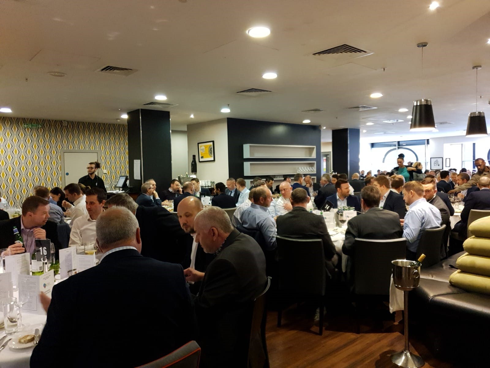 Corporate dinner event at Opus Restaurant with elegantly set tables for networking.