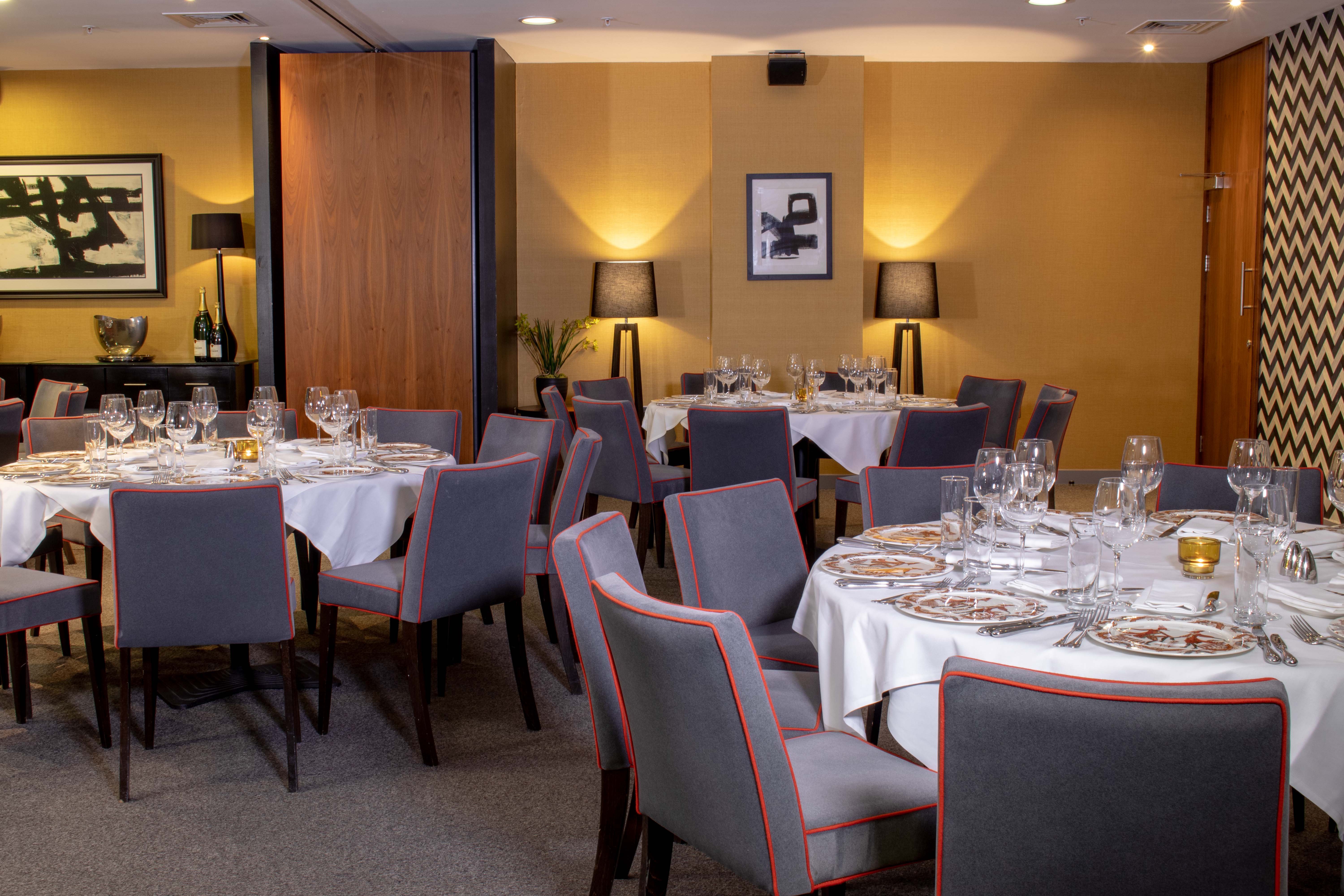 Sophisticated dining setup with round tables for corporate events at Opus Restaurant.