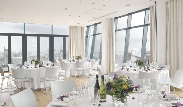 Sophisticated event space with floral centerpieces, ideal for upscale meetings and celebrations.