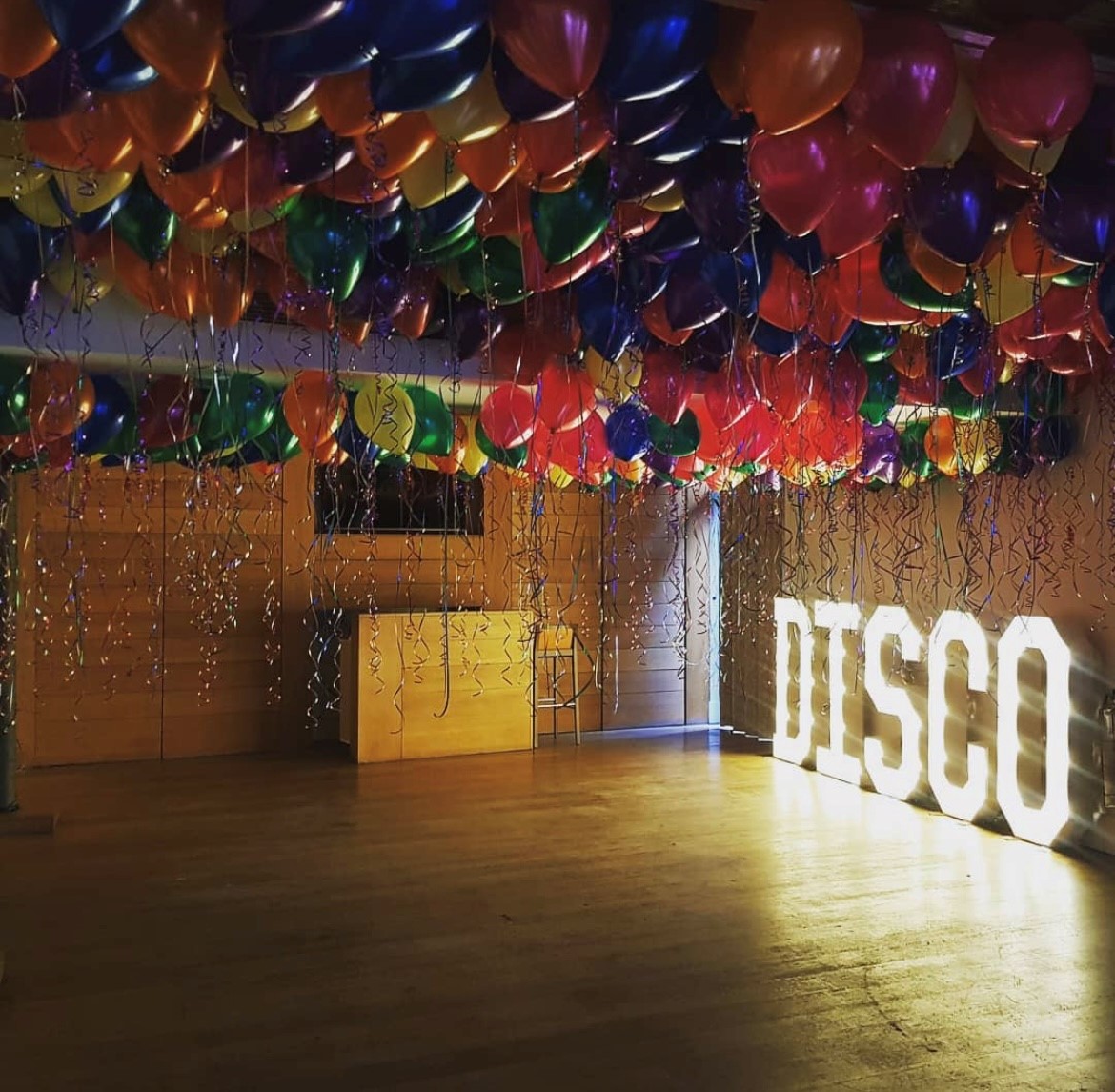 Vibrant event space with balloons and "DISCO" sign for lively celebrations at Hope Street Hotel.