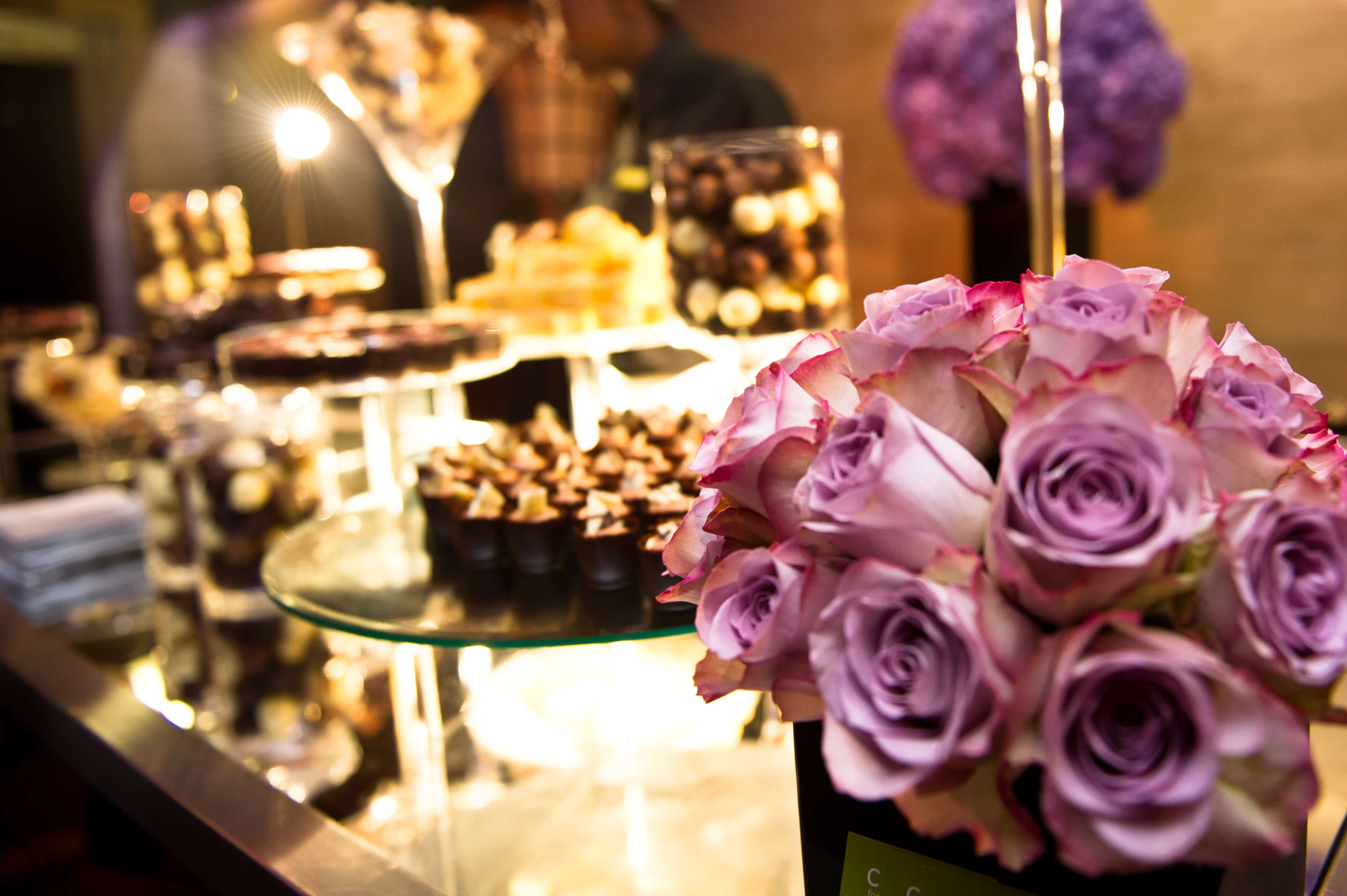 Elegant dessert display with lavender roses at The Bloomsbury Ballroom for upscale events.