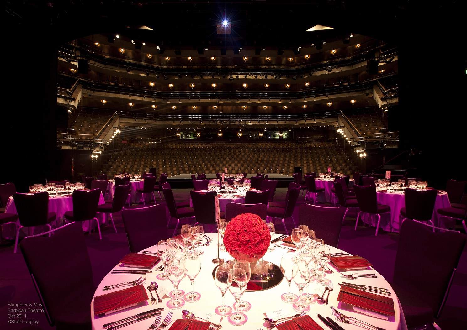 Barbican Theatre banquet setup with floral centerpieces for upscale events and galas.