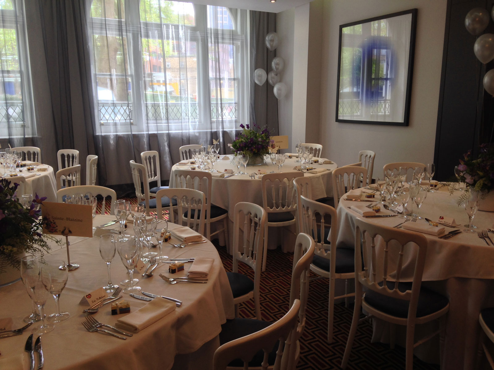 Elegant event space at Mal Lounge, London with floral centerpieces for formal gatherings.