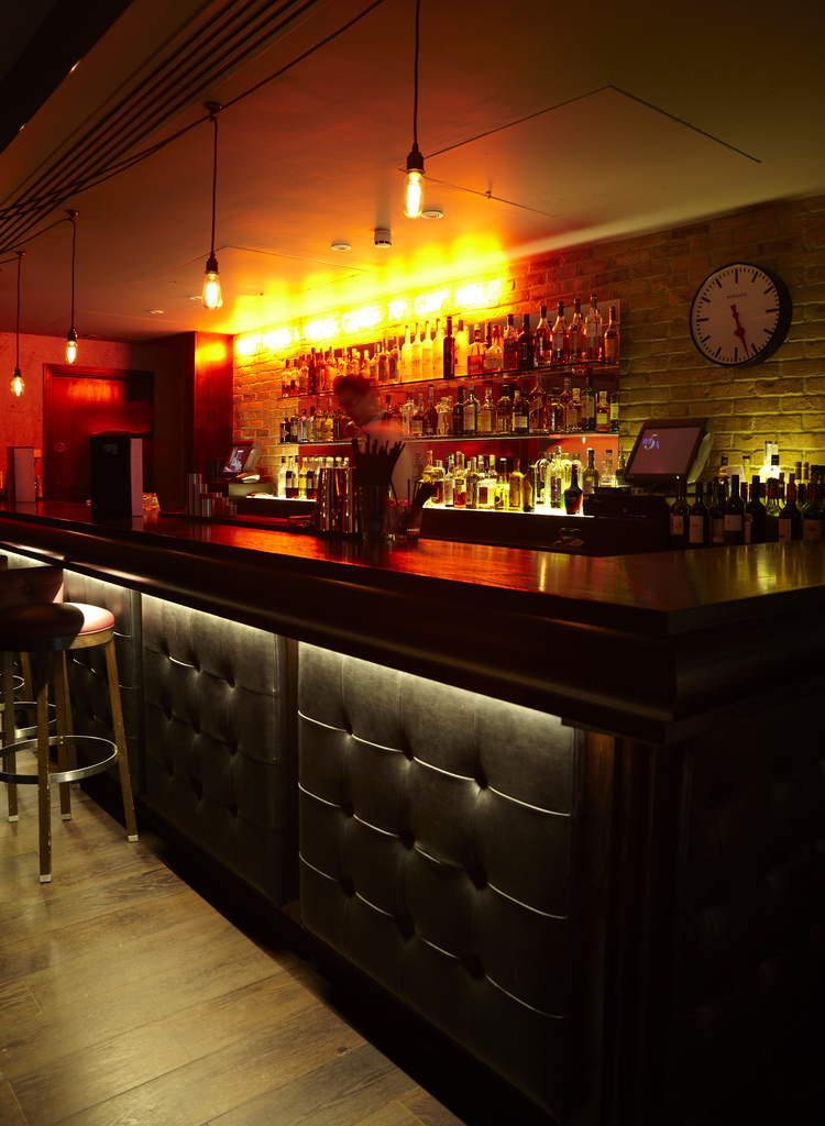 Stylish bar at Chez Mal, warm lighting for networking events in Malmaison London.