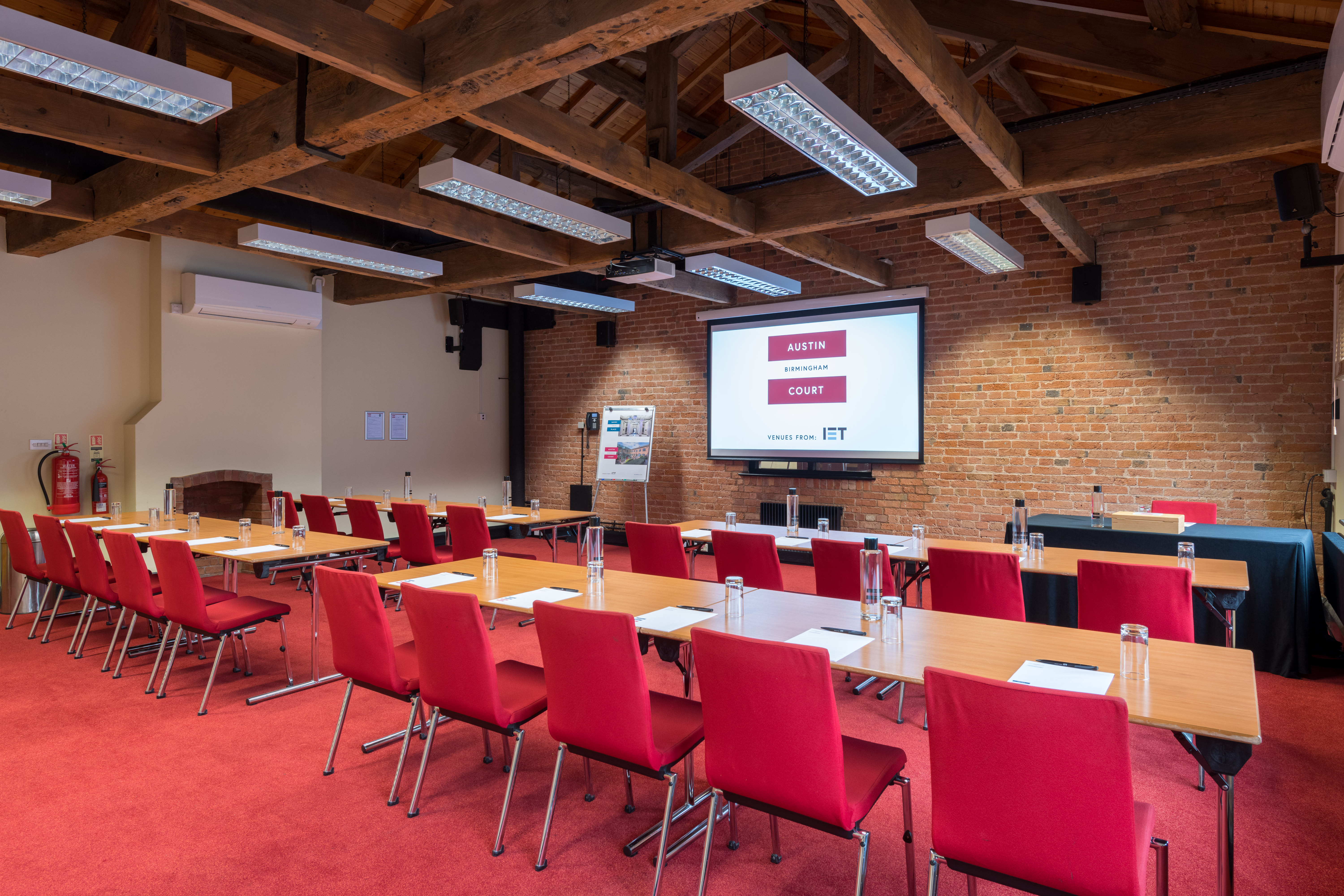 Telford Room at IET Birmingham: modern meeting space with brick wall, ideal for presentations.