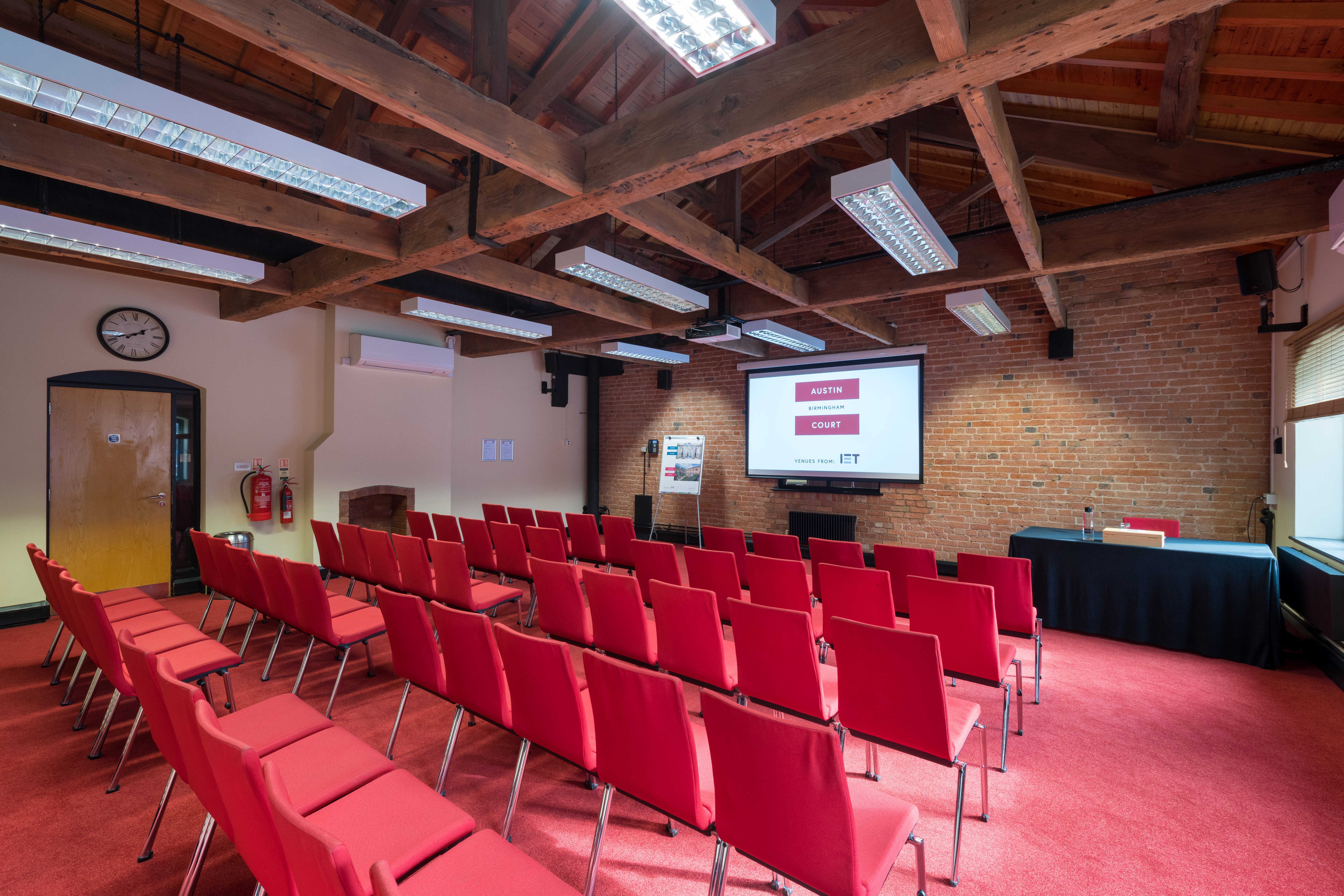 Telford Room at IET Birmingham: Austin Court, featuring red chairs for events and presentations.