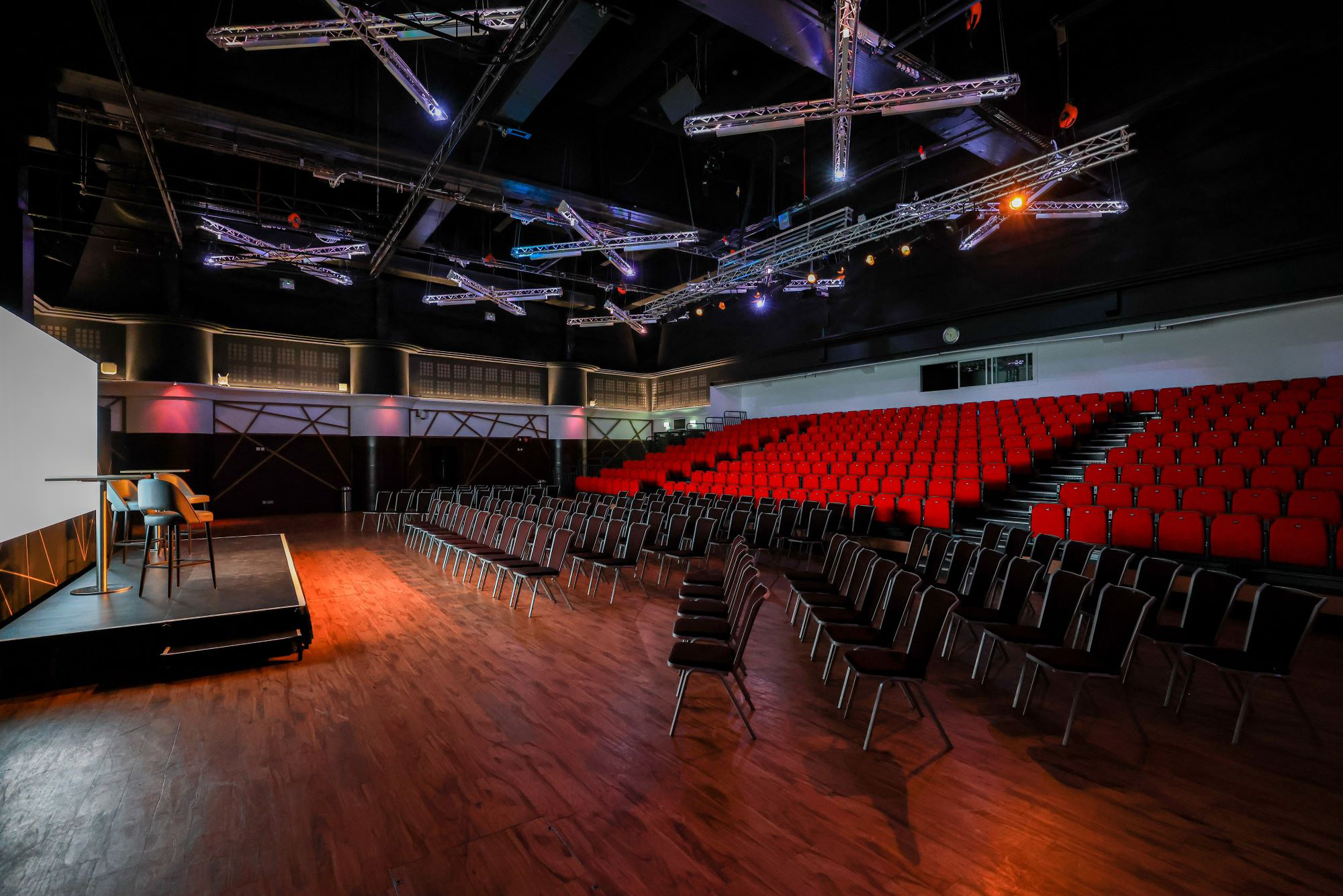 Live Room at Allianz Stadium: theater-style seating, vibrant red chairs for events.