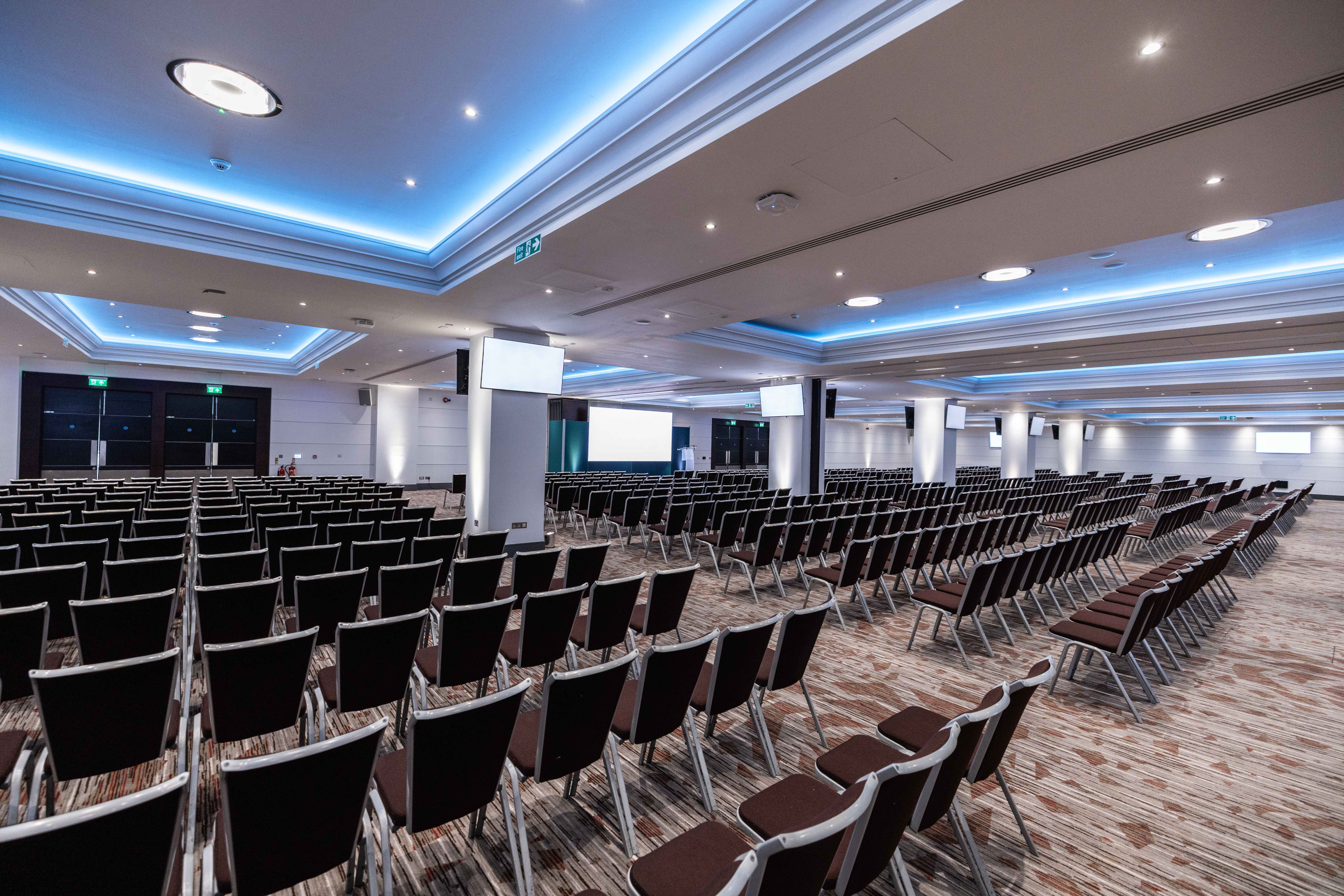 Rose Suite at Allianz Stadium, Twickenham: spacious conference venue with modern lighting.