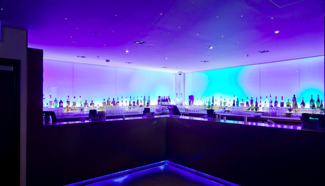 Sleek bar with purple lighting at Nuvo, ideal for networking events and cocktail receptions.