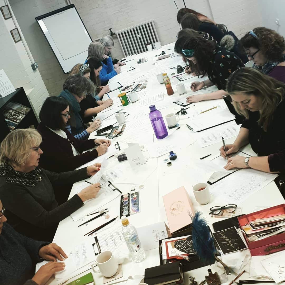 Collaborative workshop at Pen Museum, featuring diverse participants and hands-on activities.