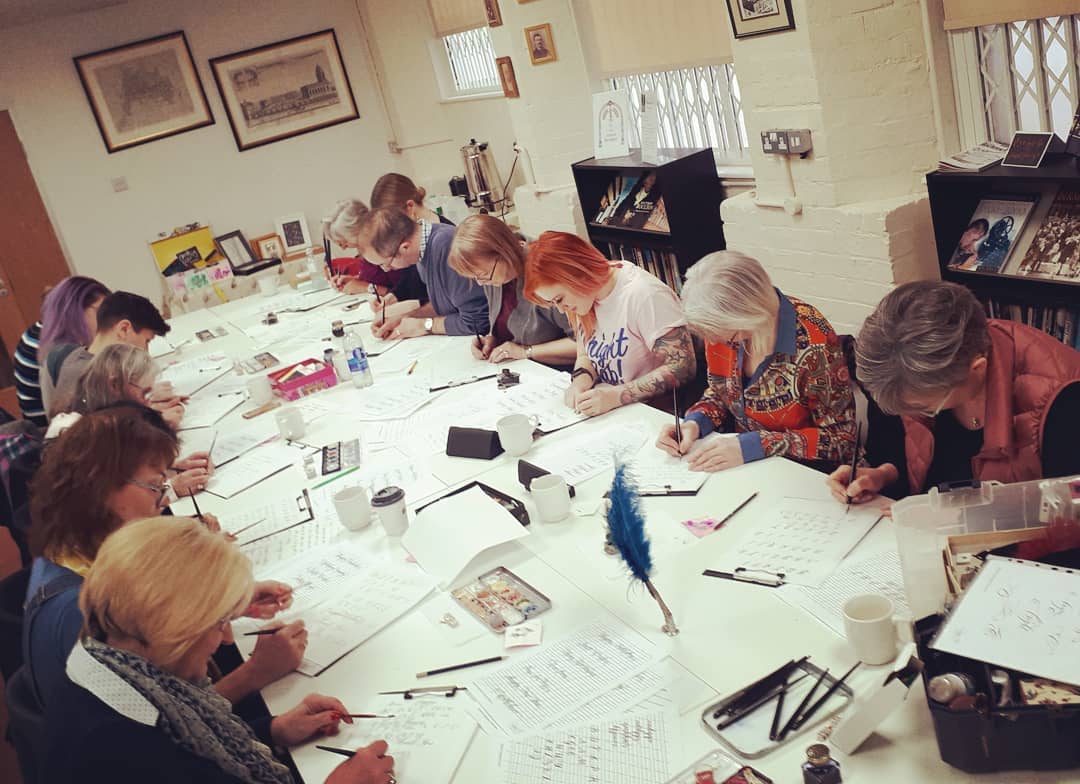 Participants in a calligraphy workshop at Pen Museum, fostering creativity and collaboration.