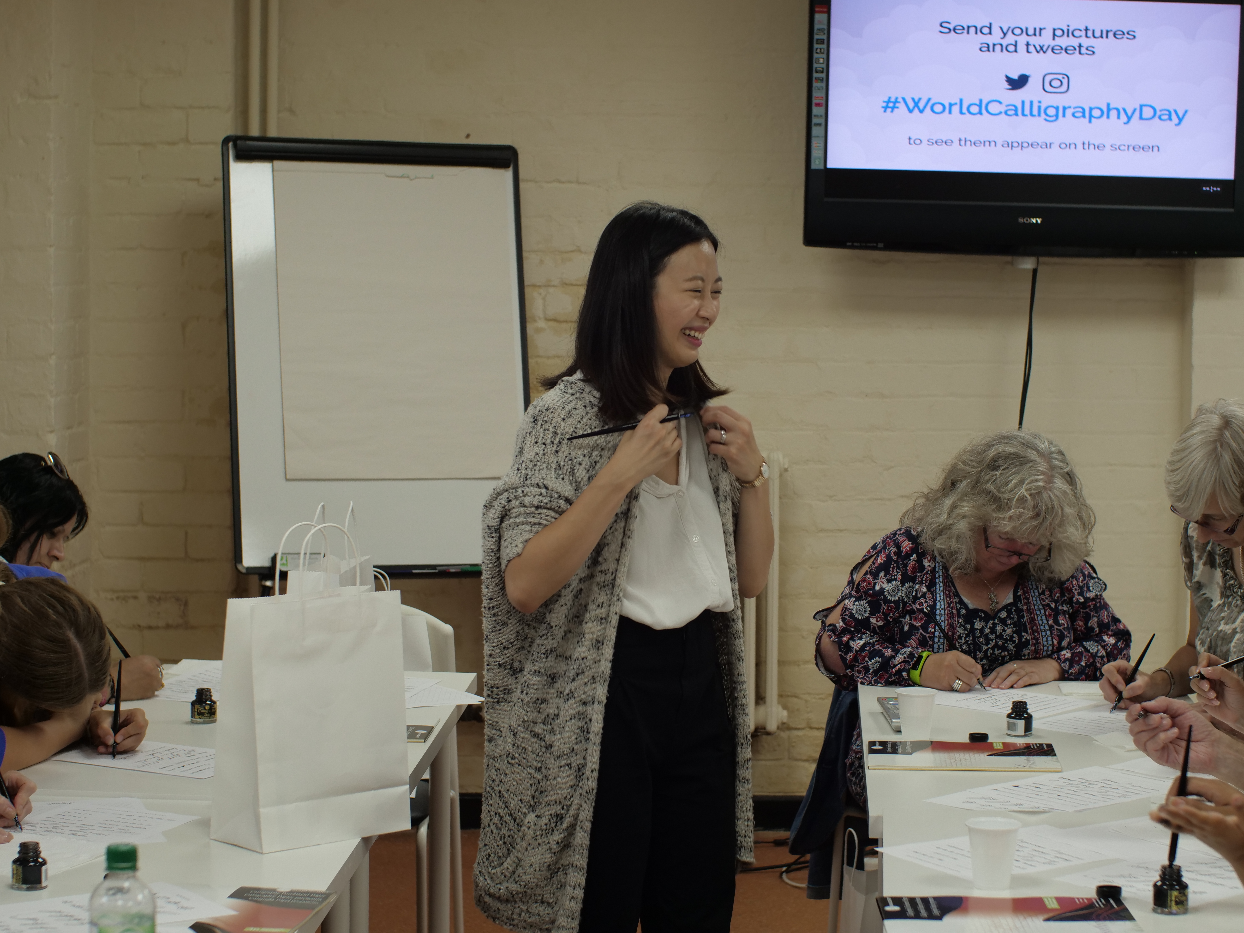 Vibrant workshop at Pen Museum, showcasing calligraphy skill development and collaboration.