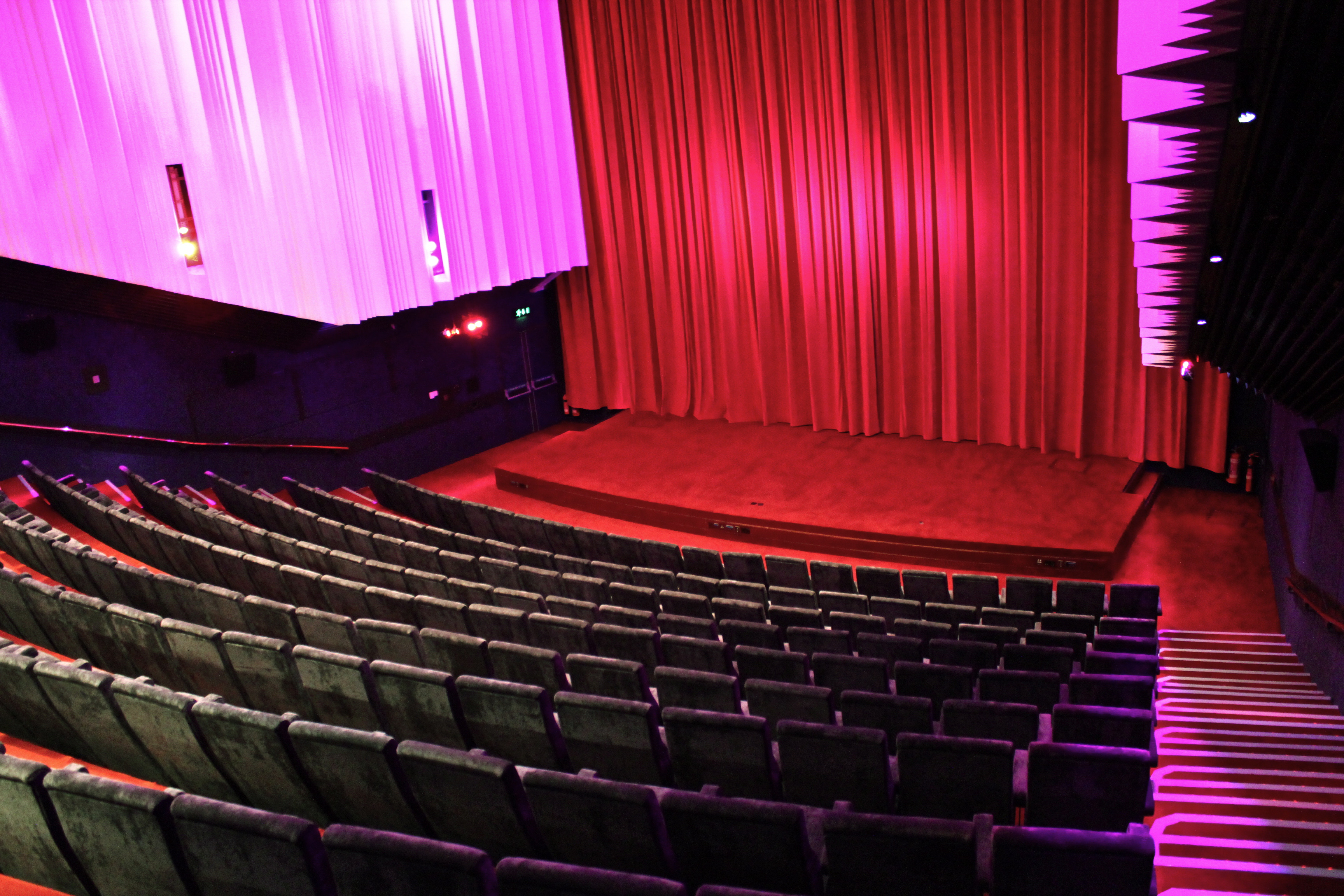 Cinema 1 at Barbican Centre: plush seating, vibrant stage for corporate events and performances.