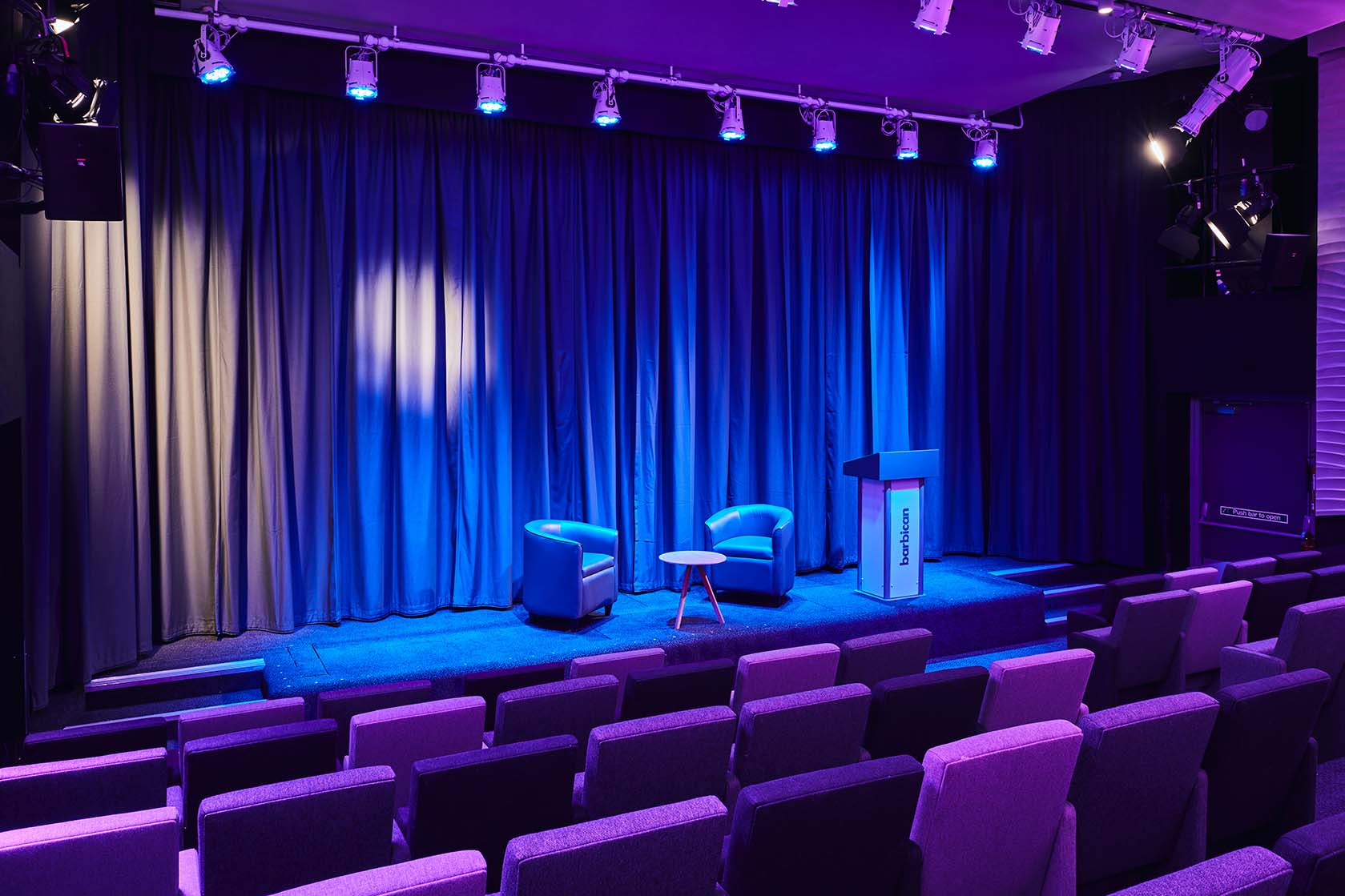 Frobisher Auditorium 1 at Barbican Centre, ideal for panel discussions with blue lighting.