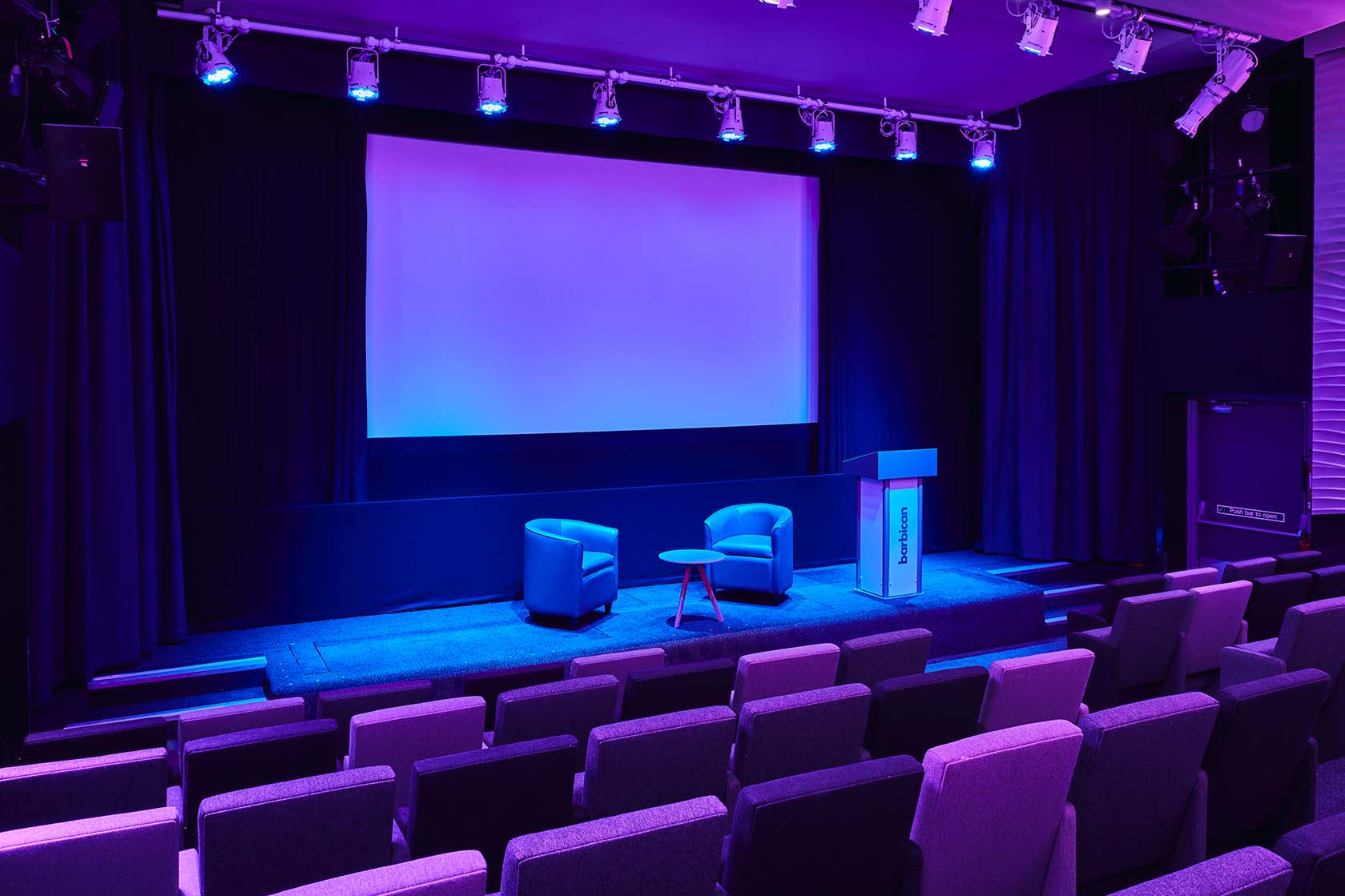 Frobisher Auditorium 1: modern event space with purple lighting for impactful meetings.